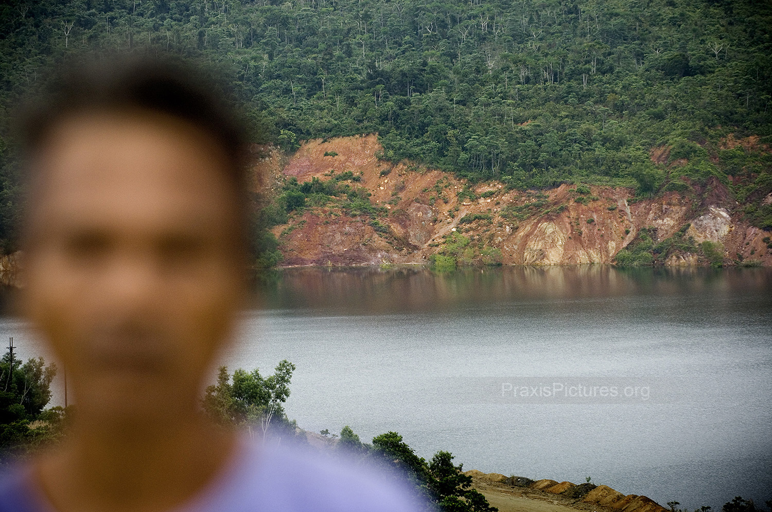 “ Look, that dam could break at any time, maybe next week, maybe tomorrow, I don’t know. But I do know that when it does happen, my house and my family will probably be destroyed. And just like last time, the company will deny responsibility. I want that picture to exist, so that people can know what happened. For that, I would be willing to sacrifice myself. ” With that a brave Marinduqueño snuck a photographer in the back of a truck into Placer Dome’s old copper mine, successfully evading the armed guards still protecting the property. Here D stands in front of the San Antonio Pit, containing the millions of tons of mine waste which will eventually come crashing down on his home. His determination to put himself in harms way for the sake of this documentation is a stronger testament to the anxiety Marinduqueños have to live with than any picture can offer.