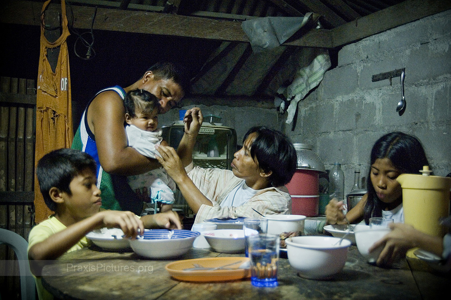 FOOD SECURITY - Pili, Mindoro, Henry (second left) and his family enjoy a meal consisting of rice, fish and vegetables. The province of Oriental Mindoro is ranked third as the province which produces the most food in the Philippines, and is known as the “food basket” of the southern Luzon region. The food security of Mindoro is under threat, however, by Crew Minerals’ (now Intex Resources) proposed nickel mine. The proposed mine site is located within a critical watershed area that provides the irrigation for 70% of the province’s vital rice fields and fruit plantations.