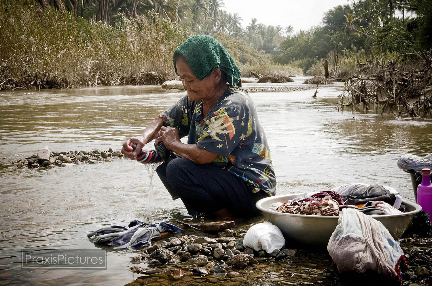 Remy washes her laundry in the poisoned Mogpog River in Marinduque. With the two main rivers on the small island now biologically dead and containing dangerous levels of toxic chemicals, many of the residents of the island are left with no safe wate…