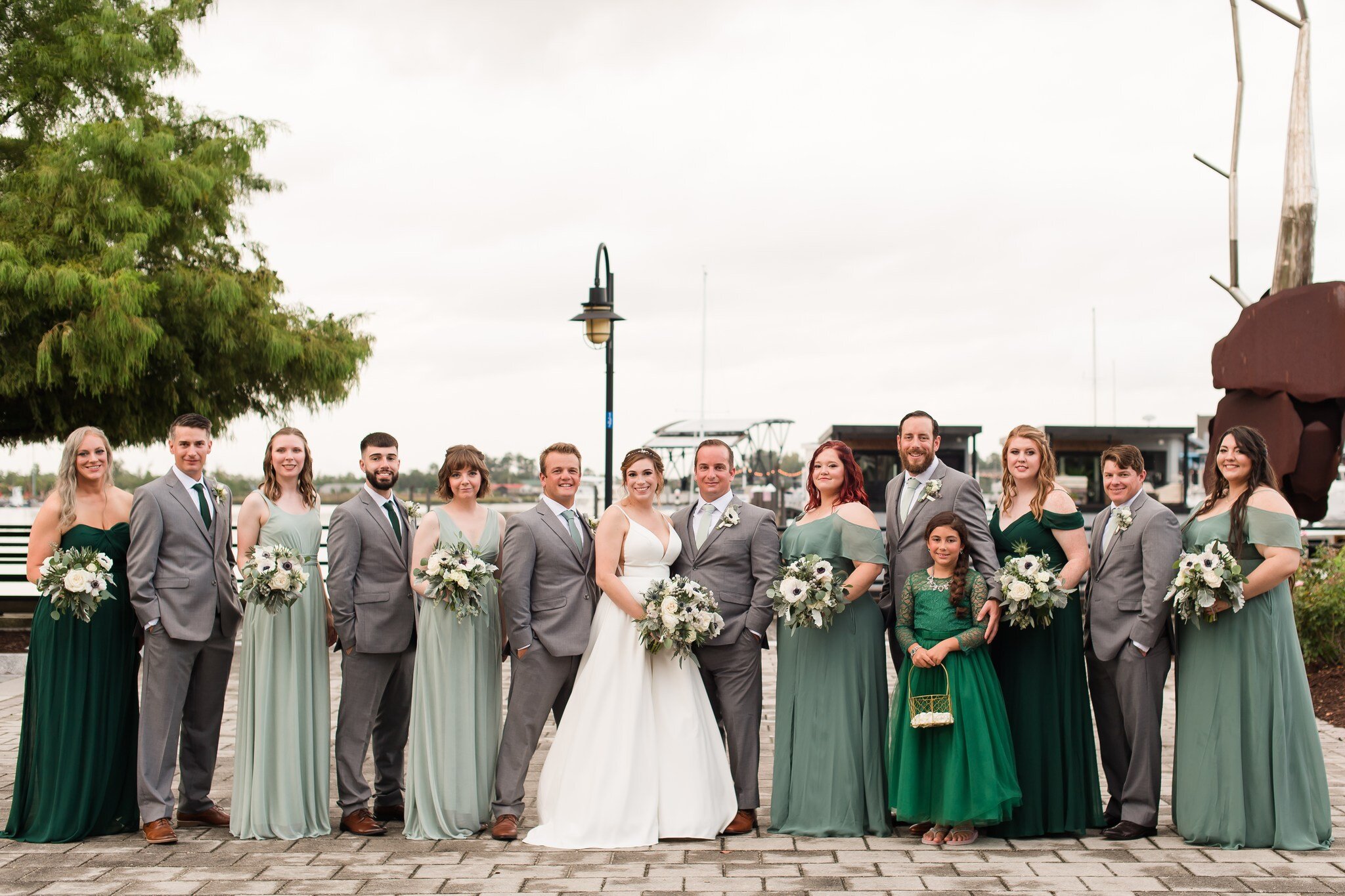 A bridal party looks GORGEOUS on the riverwalk.

Venue: Embassy Suites
DJ/Band: Brian Hood
Photographer: Michelle and Sara
Florist: @ecochicblossoms 
Catering: Embassy Suites
Baker: @onebellebakery 
Rentals: @designsbydillonnc / @lltentandpartyrental