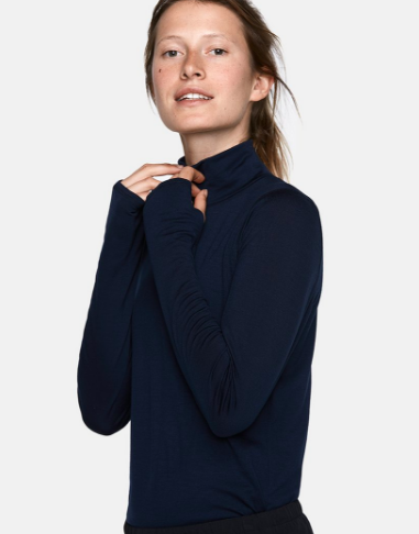 Outdoor Voices is a great brand to look at! Their looks are modern and chic. This merino wool top also looks great with jeans and a vest, for those days you can go a bit more casual.
