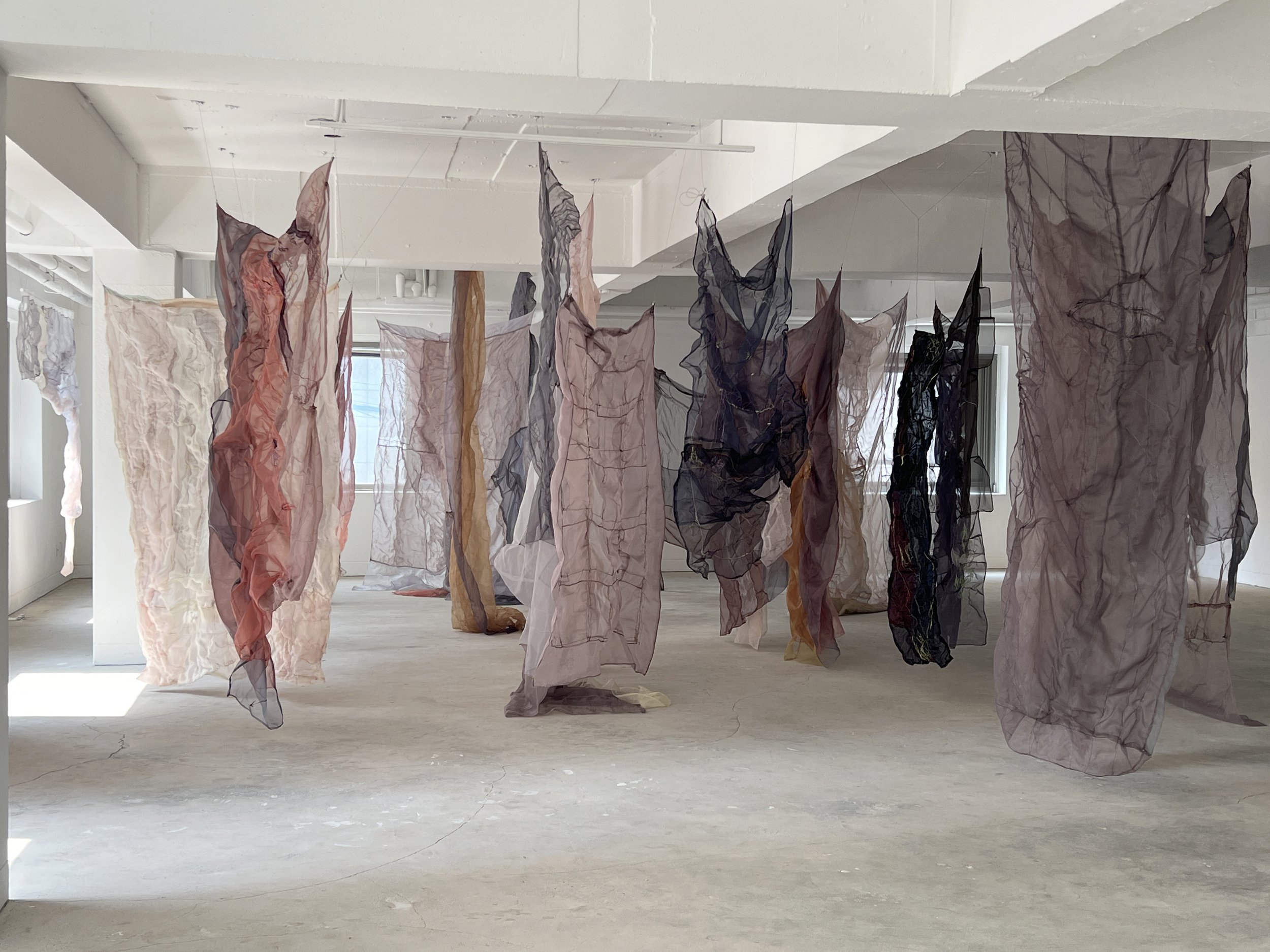 Installation Video Each piece will be suspended without a fixed pattern, some leaning toward each other as if in conversation, others standing apart. Like people murmuring in a room, the arrangement forms an organic field that shifts quietly in res