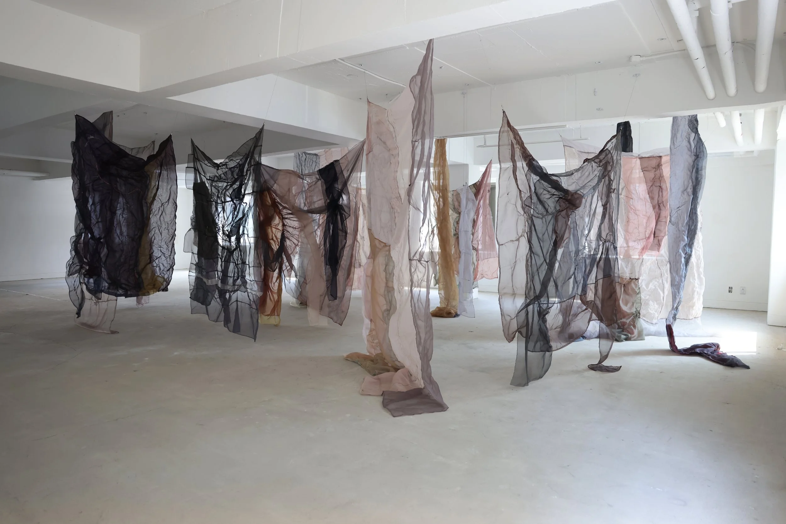  The clusters of fabric shift dramatically depending on the viewer’s angle and position. What first appears as a single form soon fragments into multiple layers, each suggesting its own story. One viewer described the moment as if the fabric, or the 