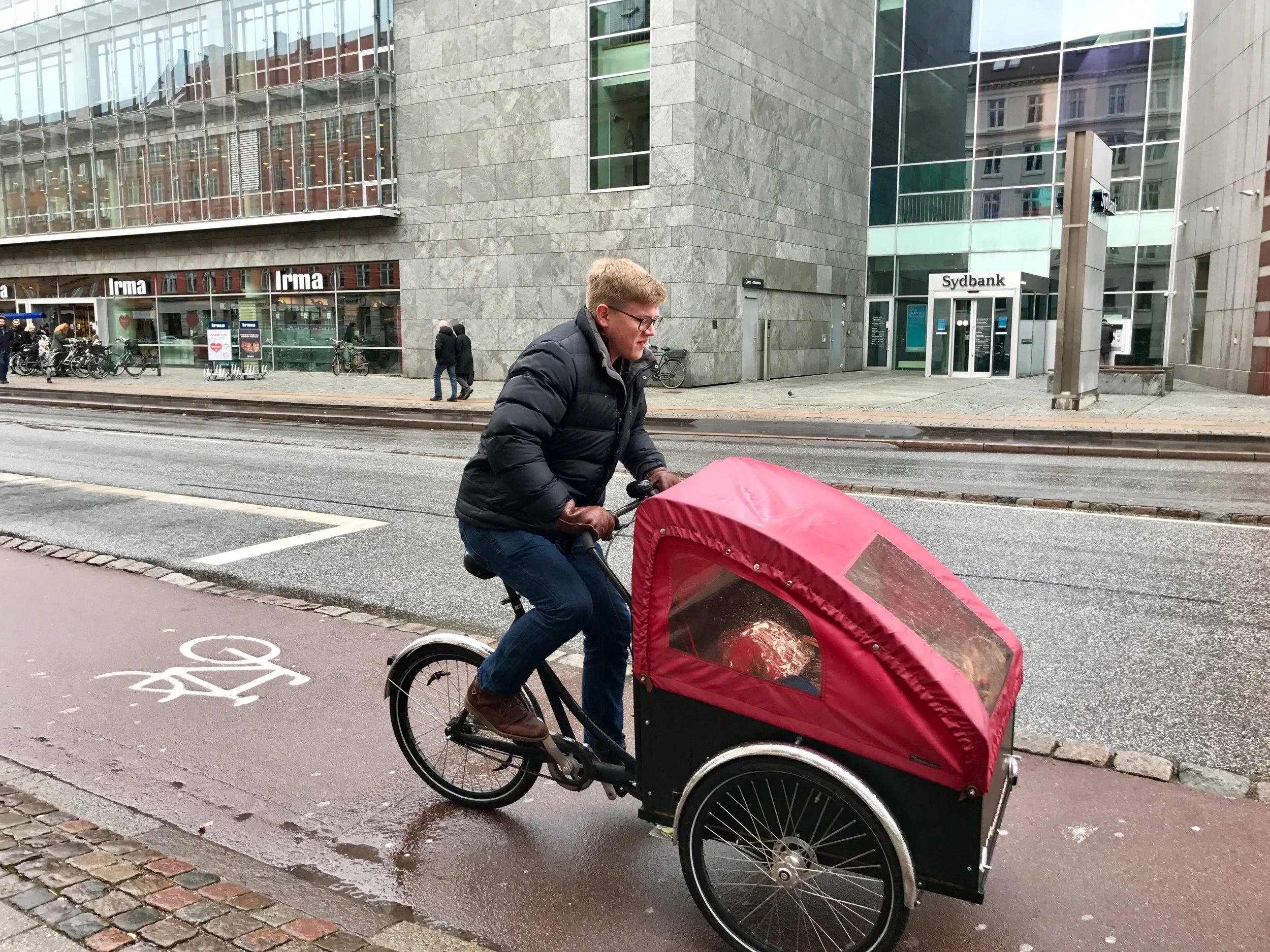 Sam transporting the Thanksgiving meal, including a pre-ordered turkey to the party on a Christiania bike