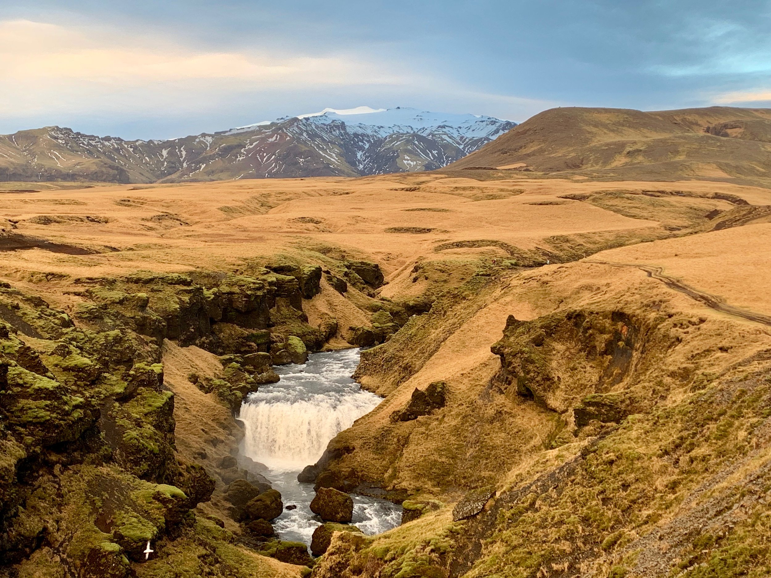 Skogafoss gorge with Eyjafjallajökull glacier in the background