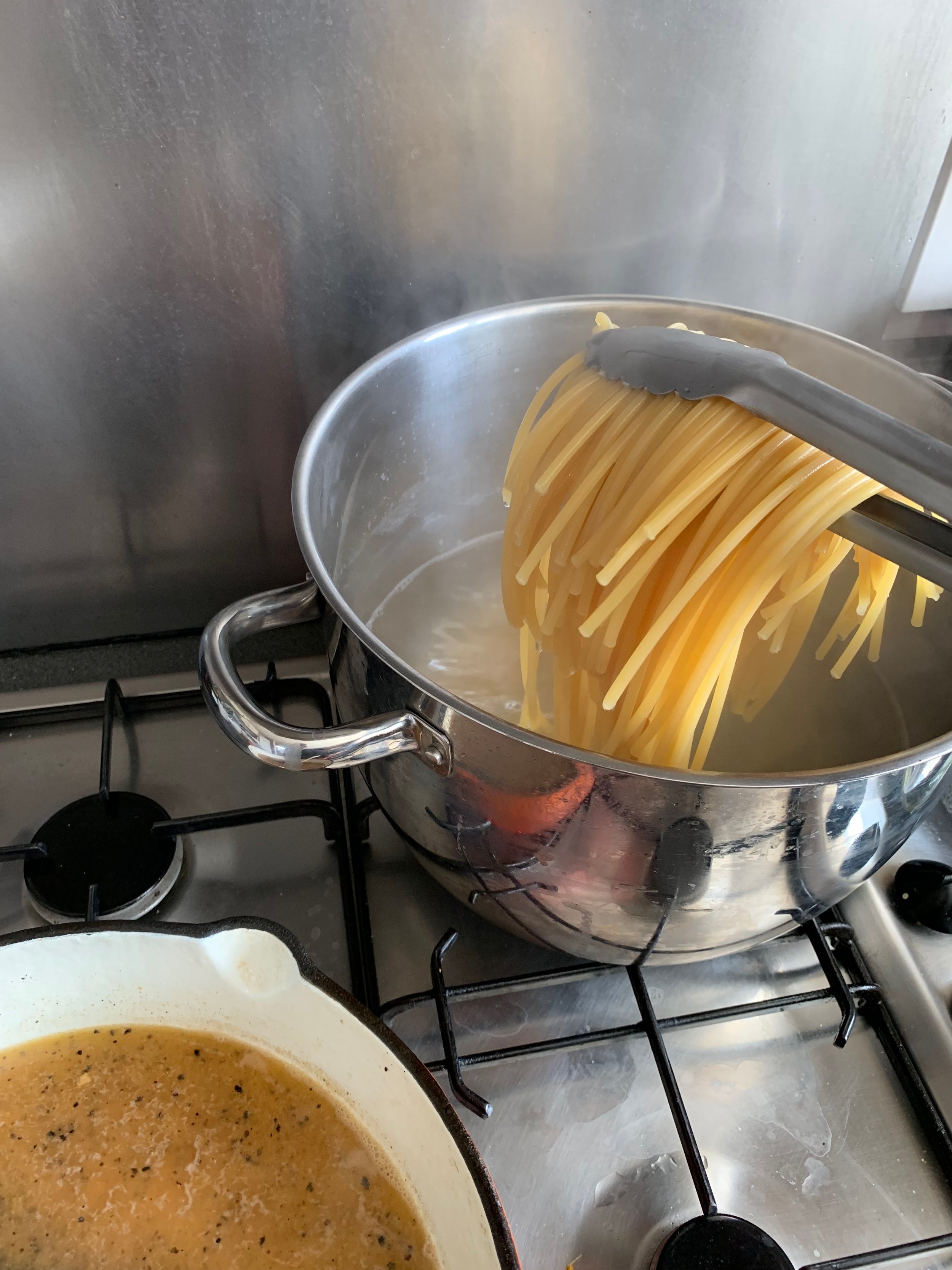 Pasta getting transferred to the skillet