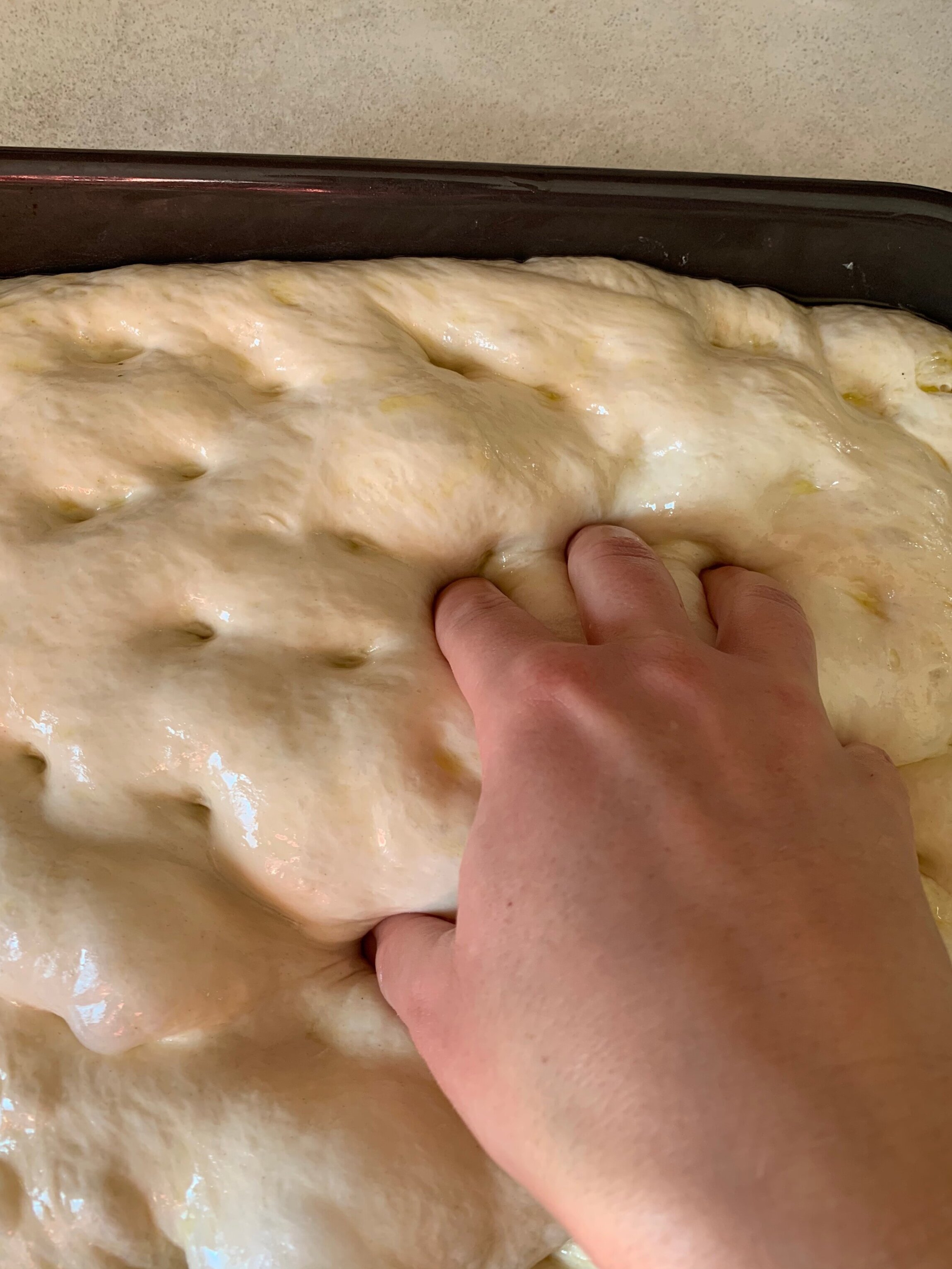 Dimpling the focaccia dough