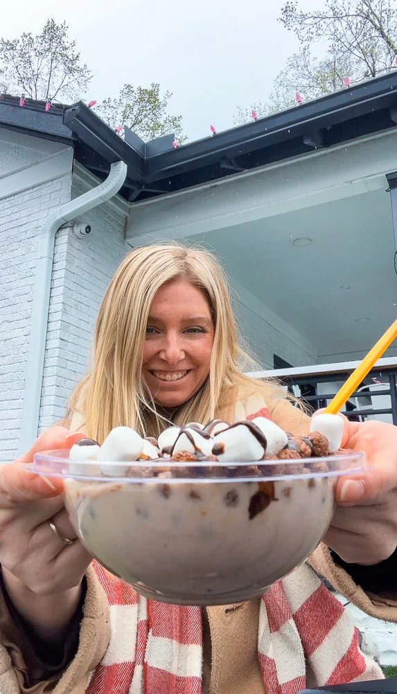 woman holding up a bowl of cereal