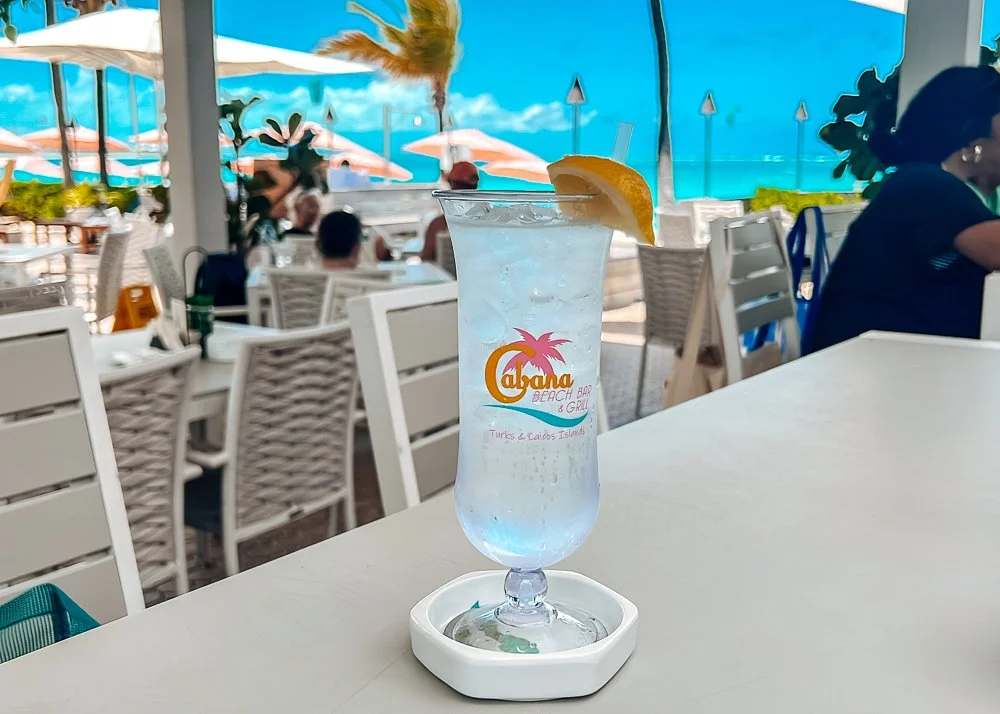 Glass of water with ocean in the background