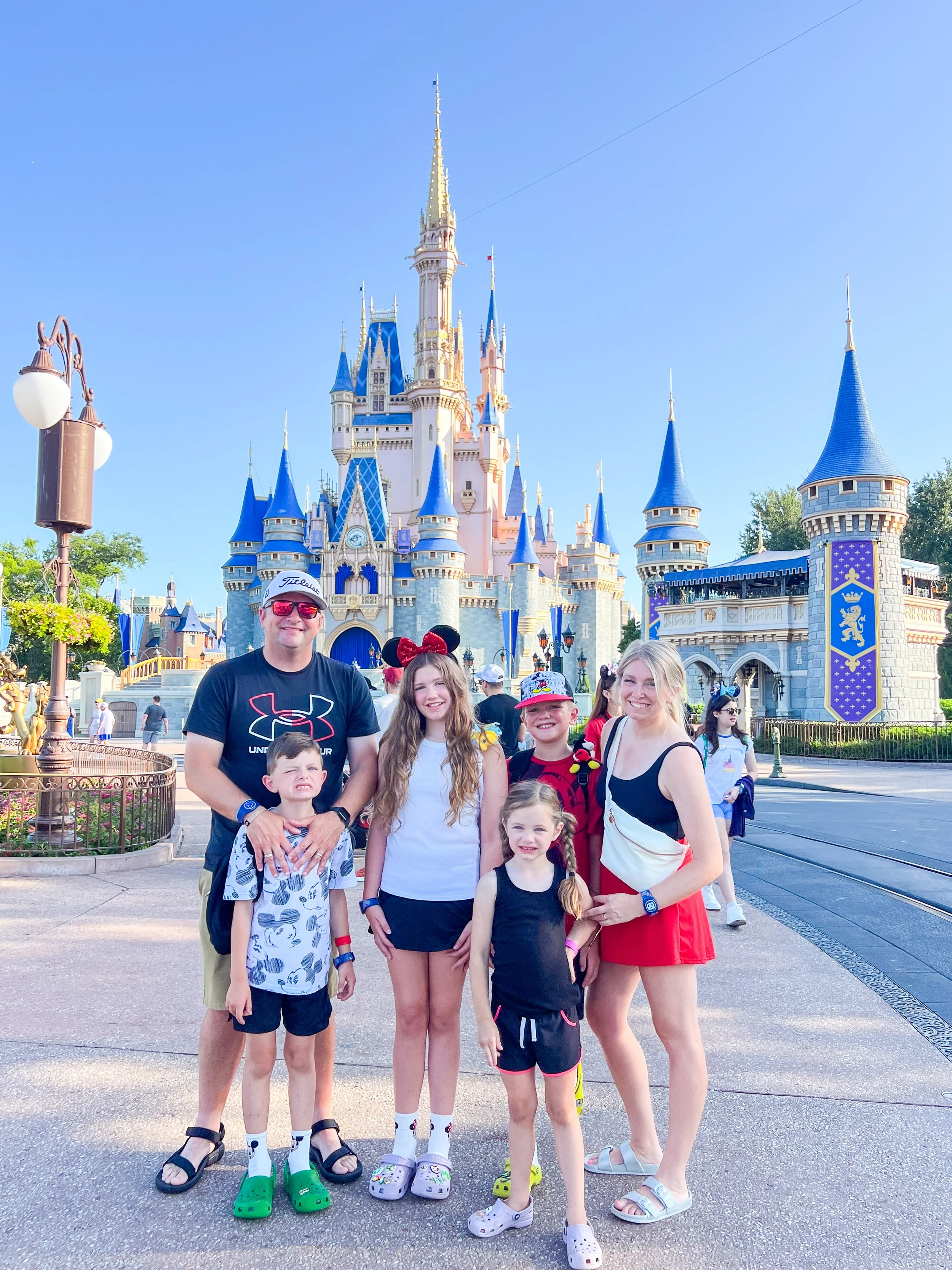 family standing in front of the castle at Magic Kingdom