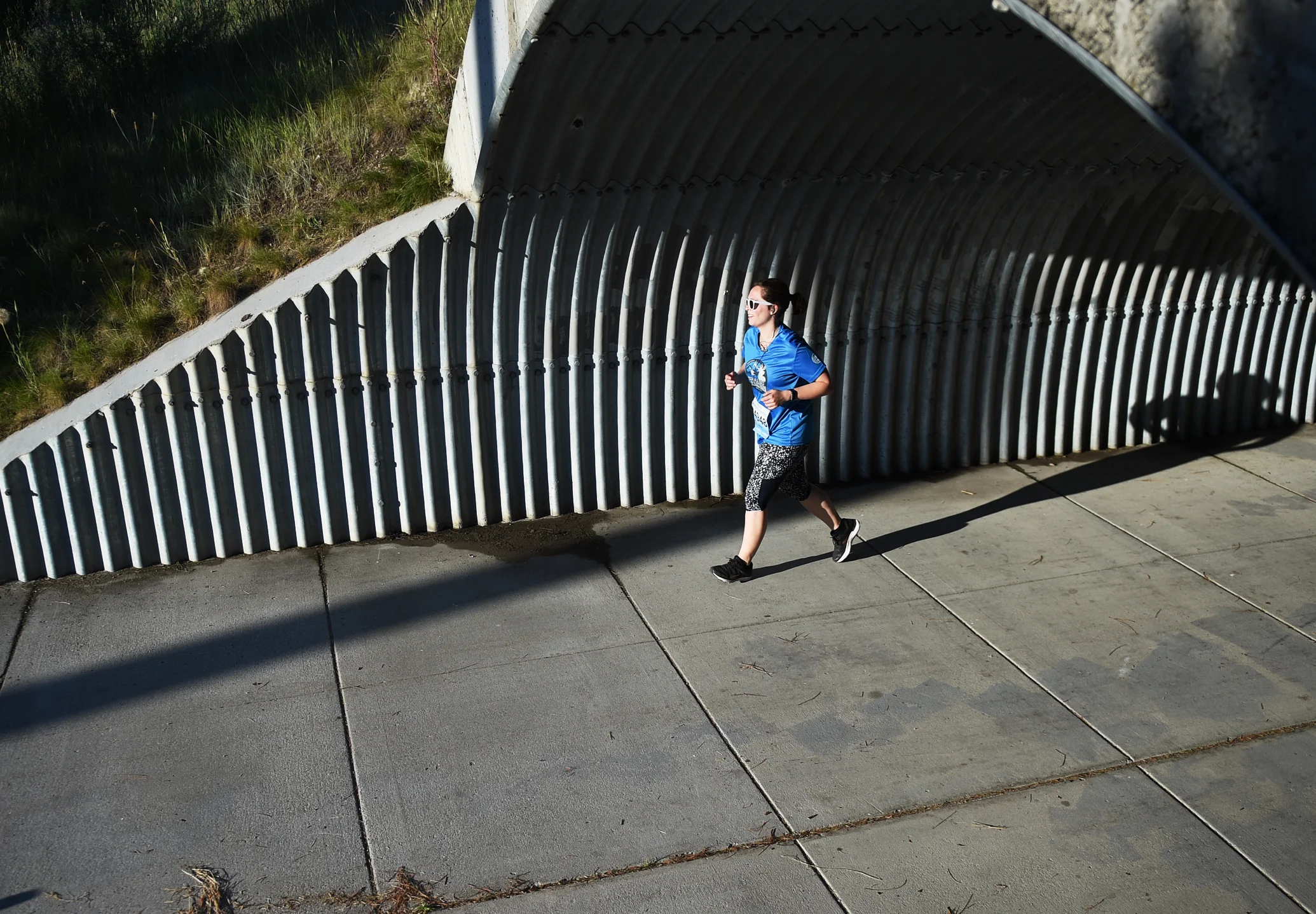 Eliza Warner, from San Francisco, Calf, exits the Reserve Street tunnel just after the halfway point for the half marathon competitors.