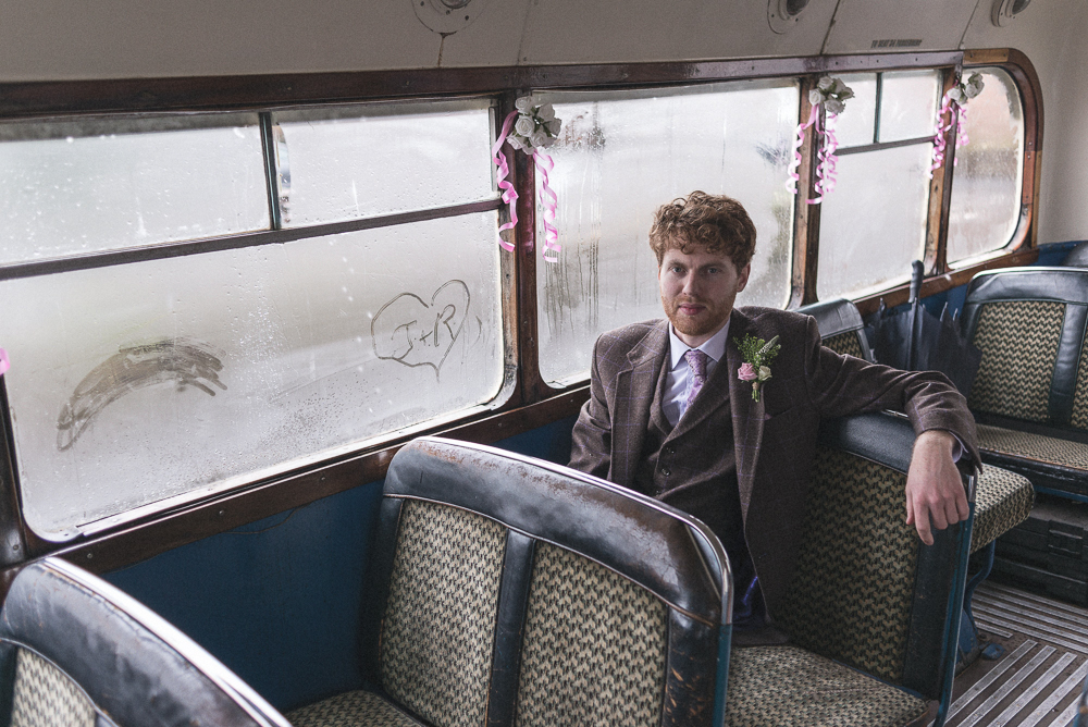 Groom sits in wedding bus waiting for service to begin in Croston