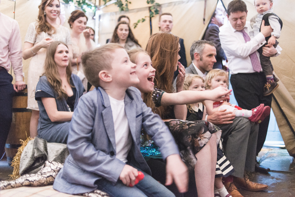Children laugh during wedding punch and judy show in Croston Old School