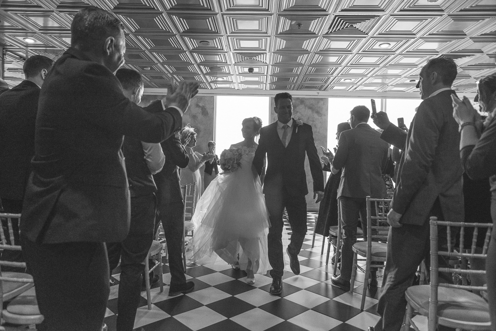 Bride and groom walk down the aisle in Media City, Salford