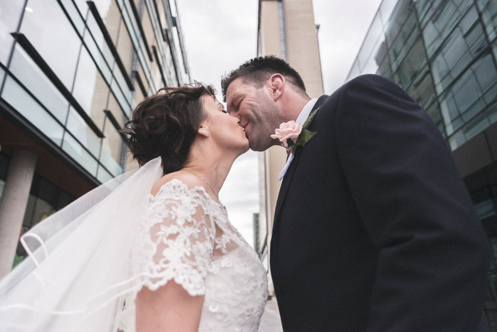 Bride and groom kiss, Salford wedding photographer