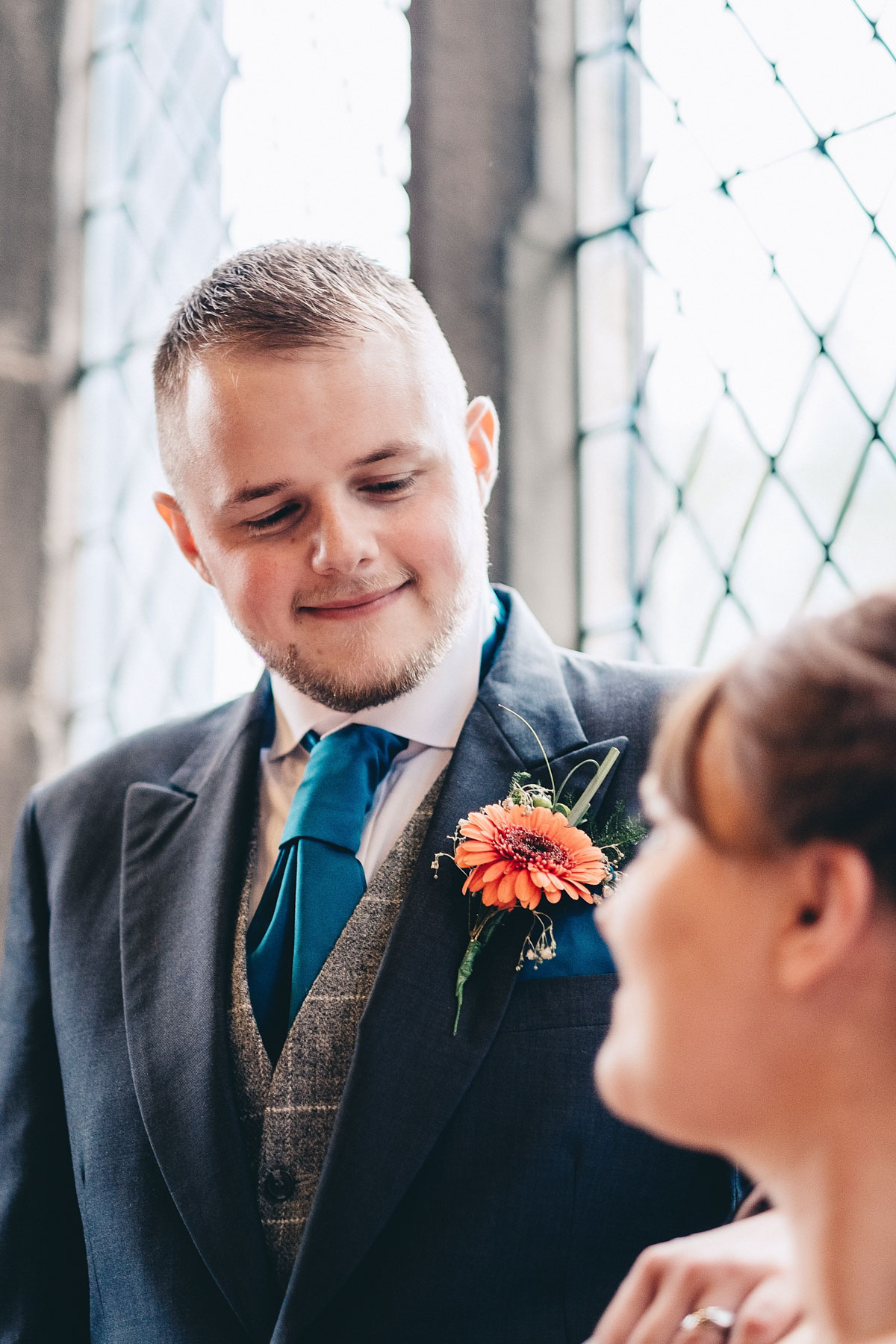 Groom looks down at his new wife