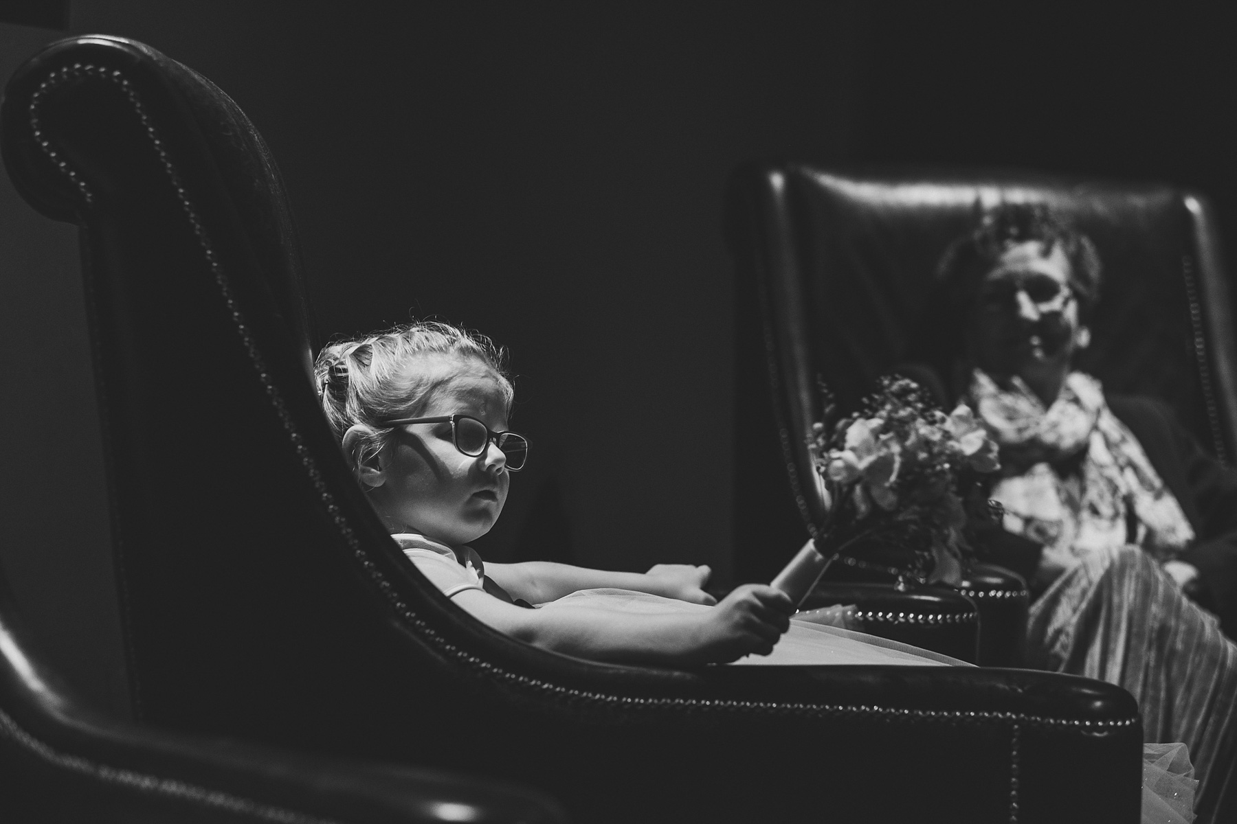 A Bridesmaid looks on in a dark reception