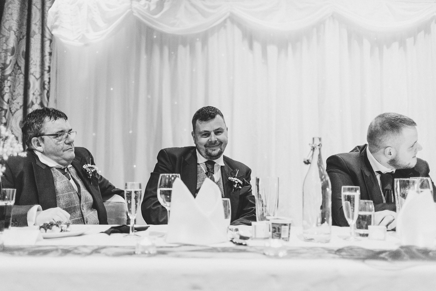 Groom and bestman look on during wedding speeches