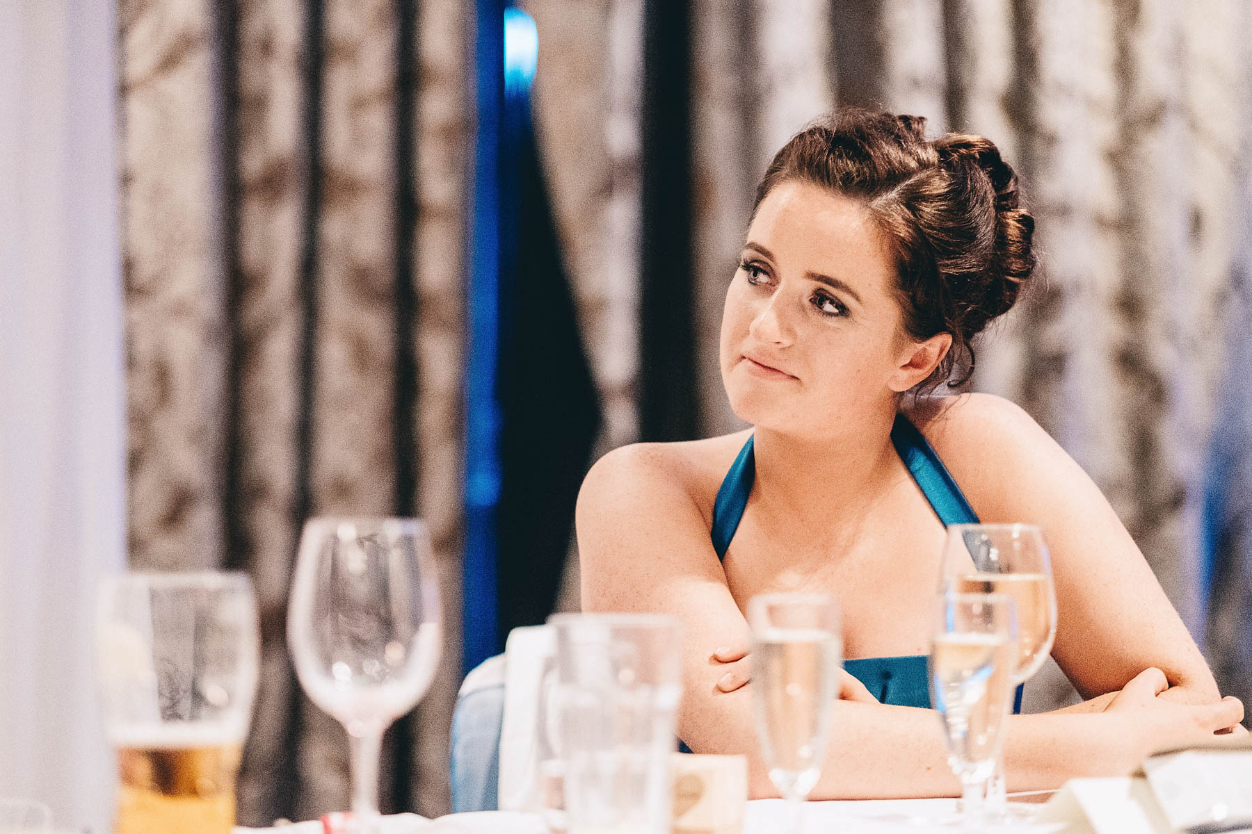 Bridesmaid looks on during speech