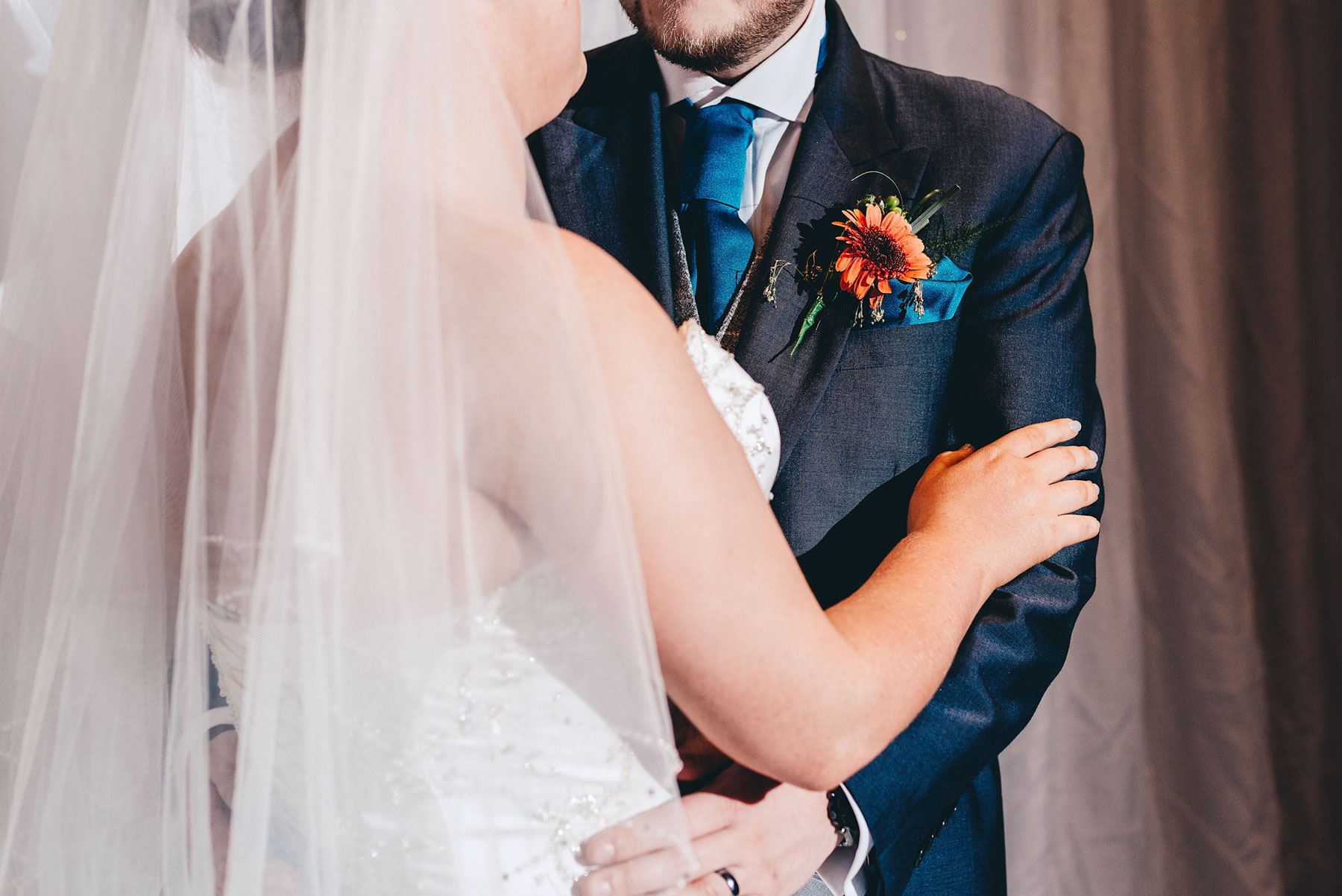 Close up of bride and grooms torso