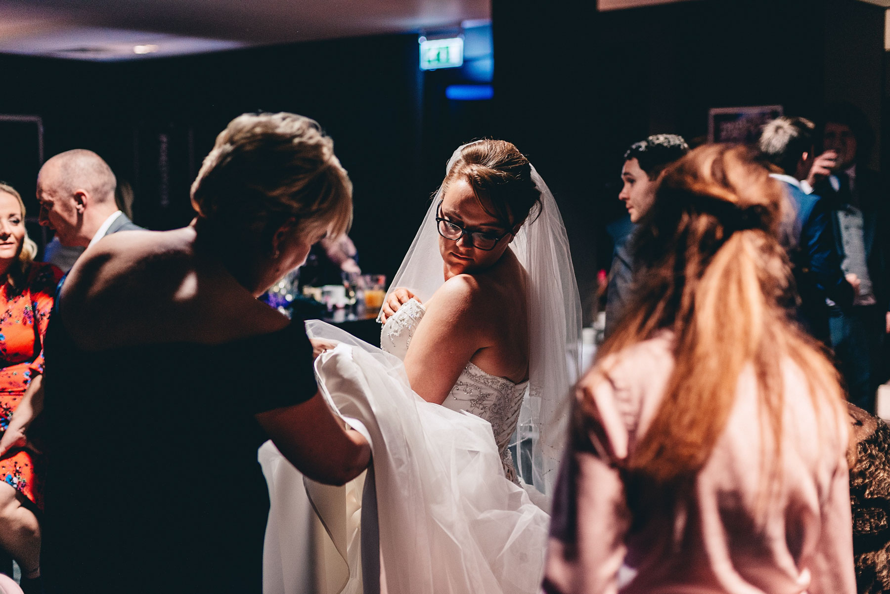 Bride looks down at her dress