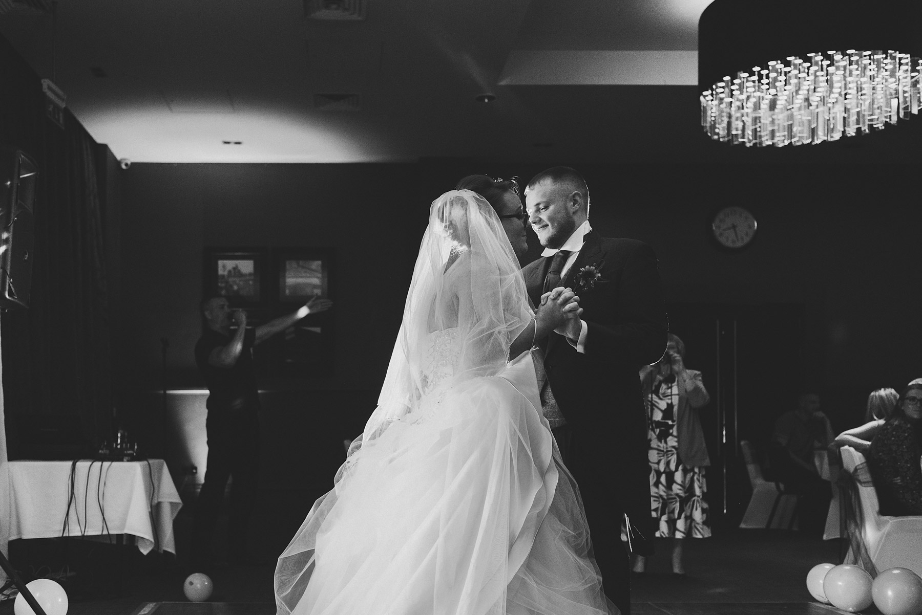 Black and white picture of bride and groom having the first dance
