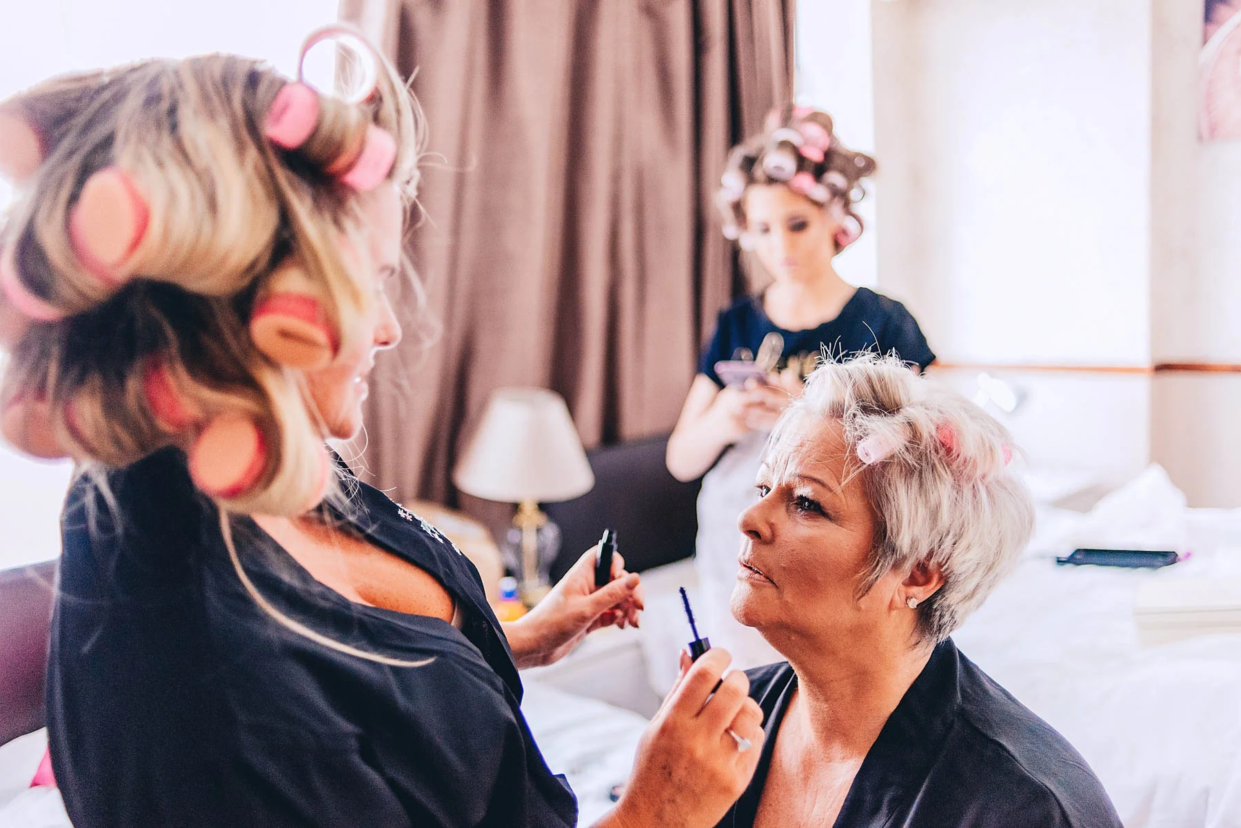 Bride getting makeup applied in the morning
