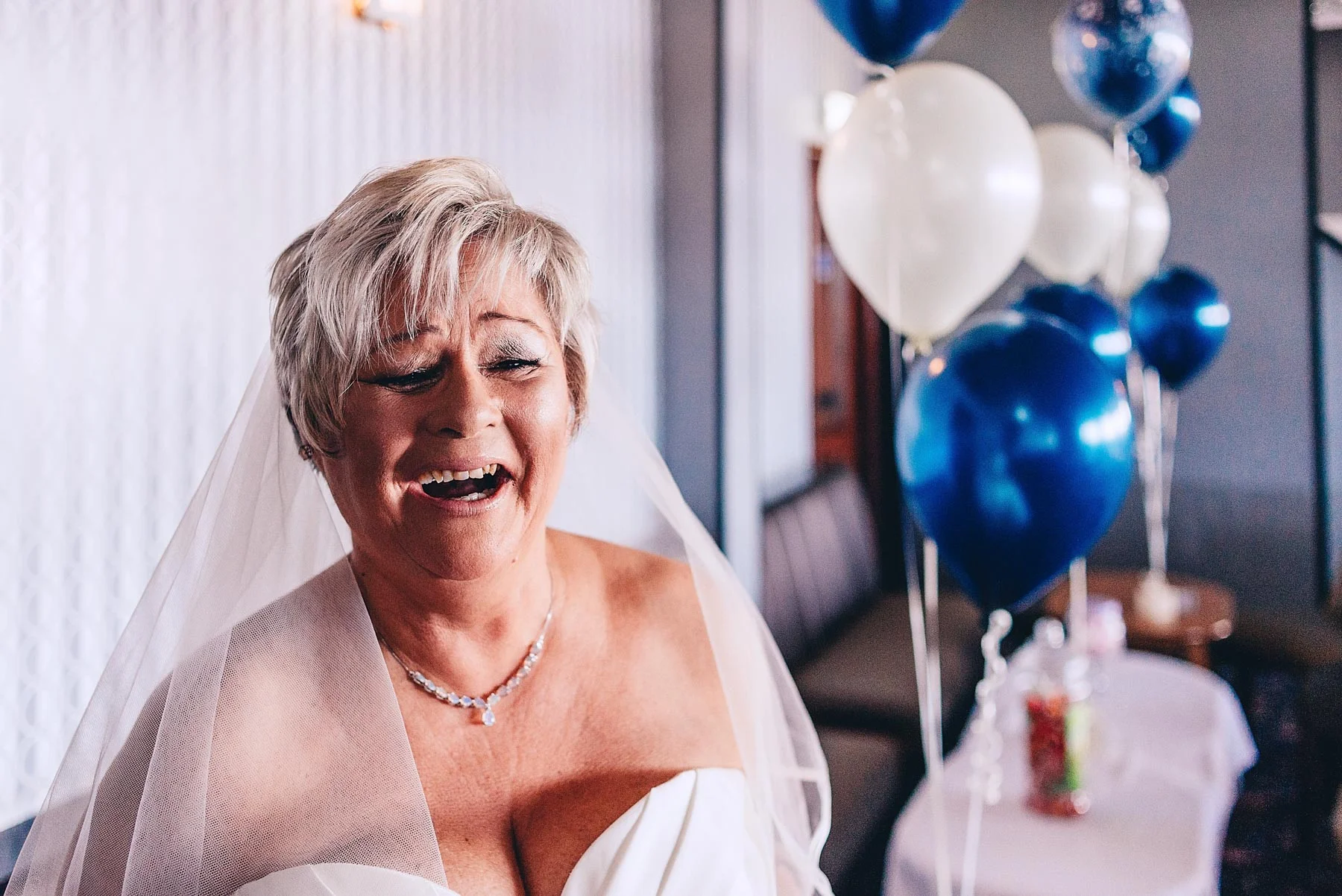 Bride laughs on the wedding day morning