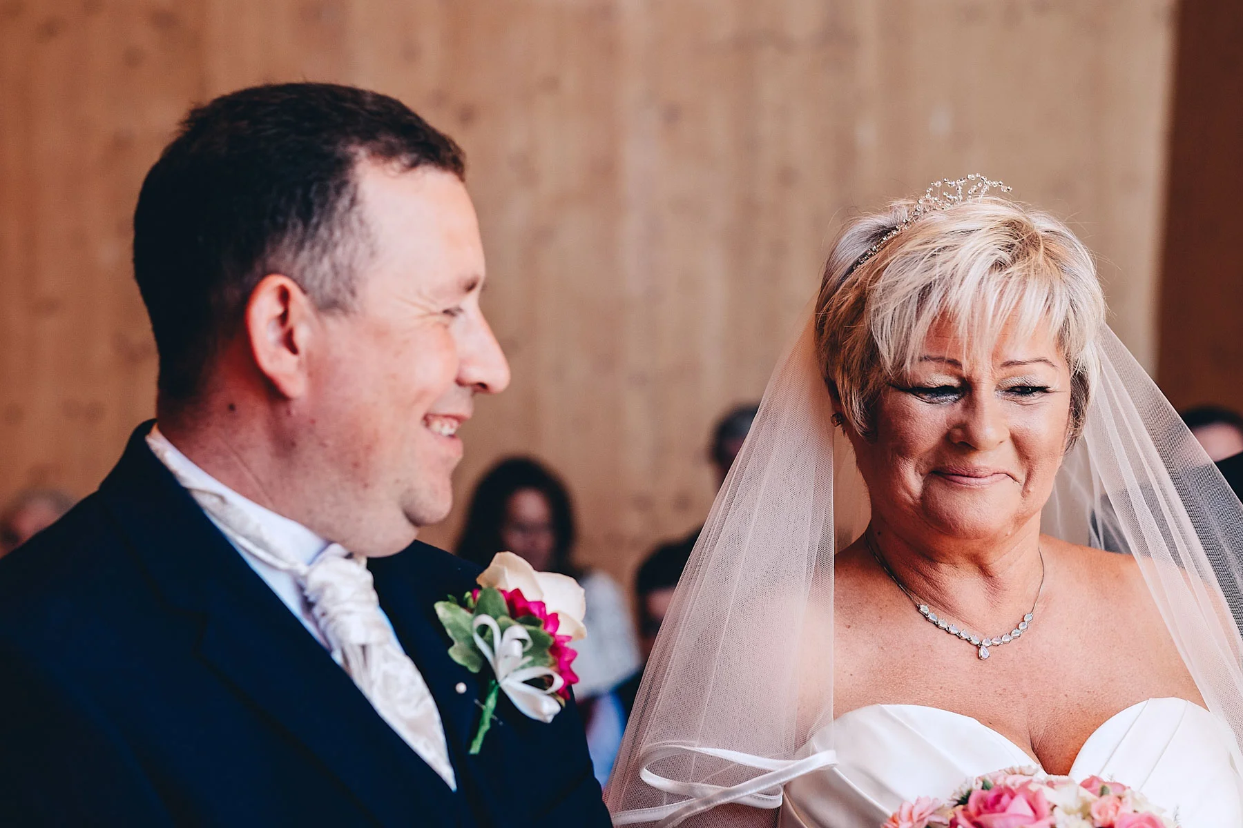 Groom smiles at bride