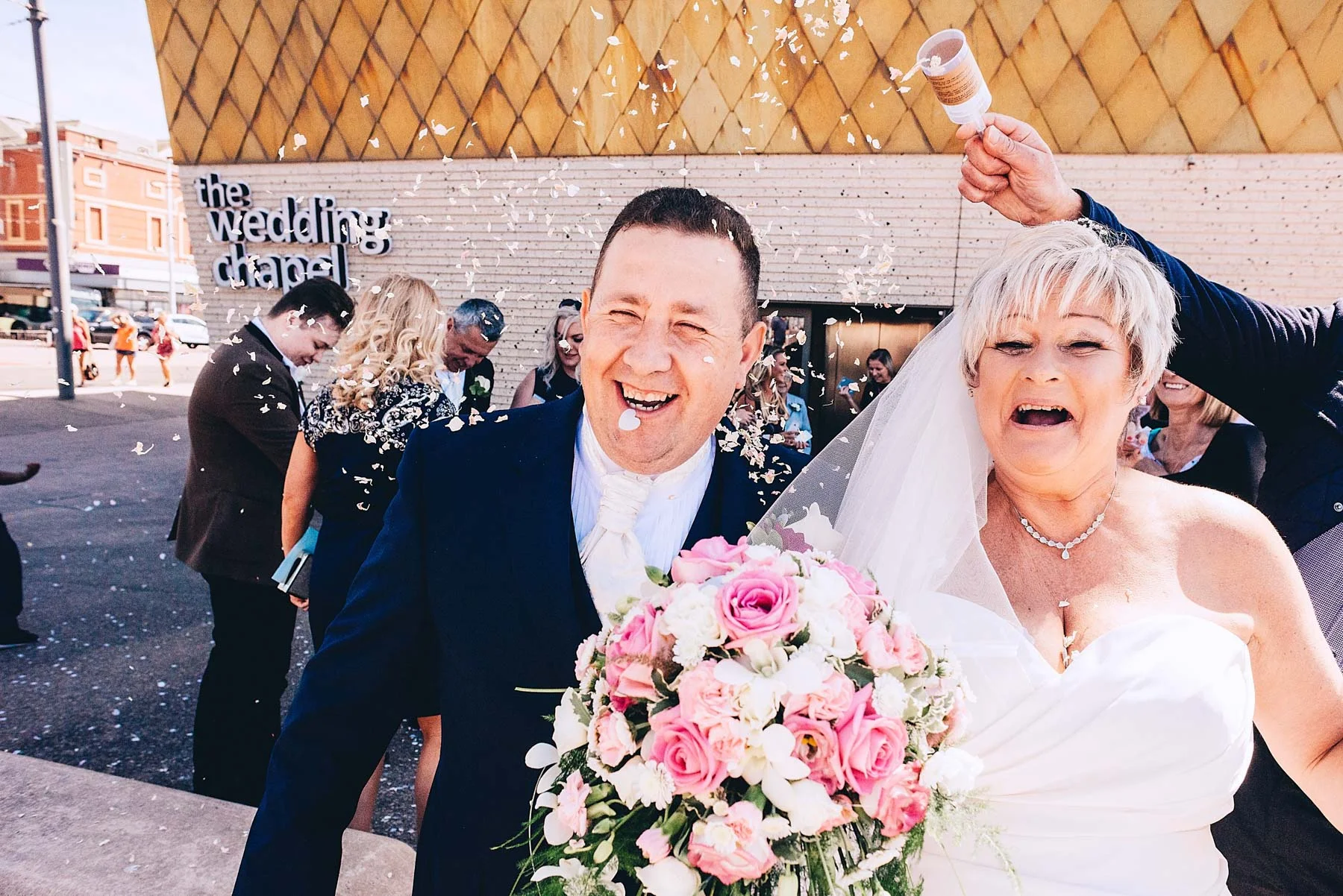 Bride and Groom laugh after confetti