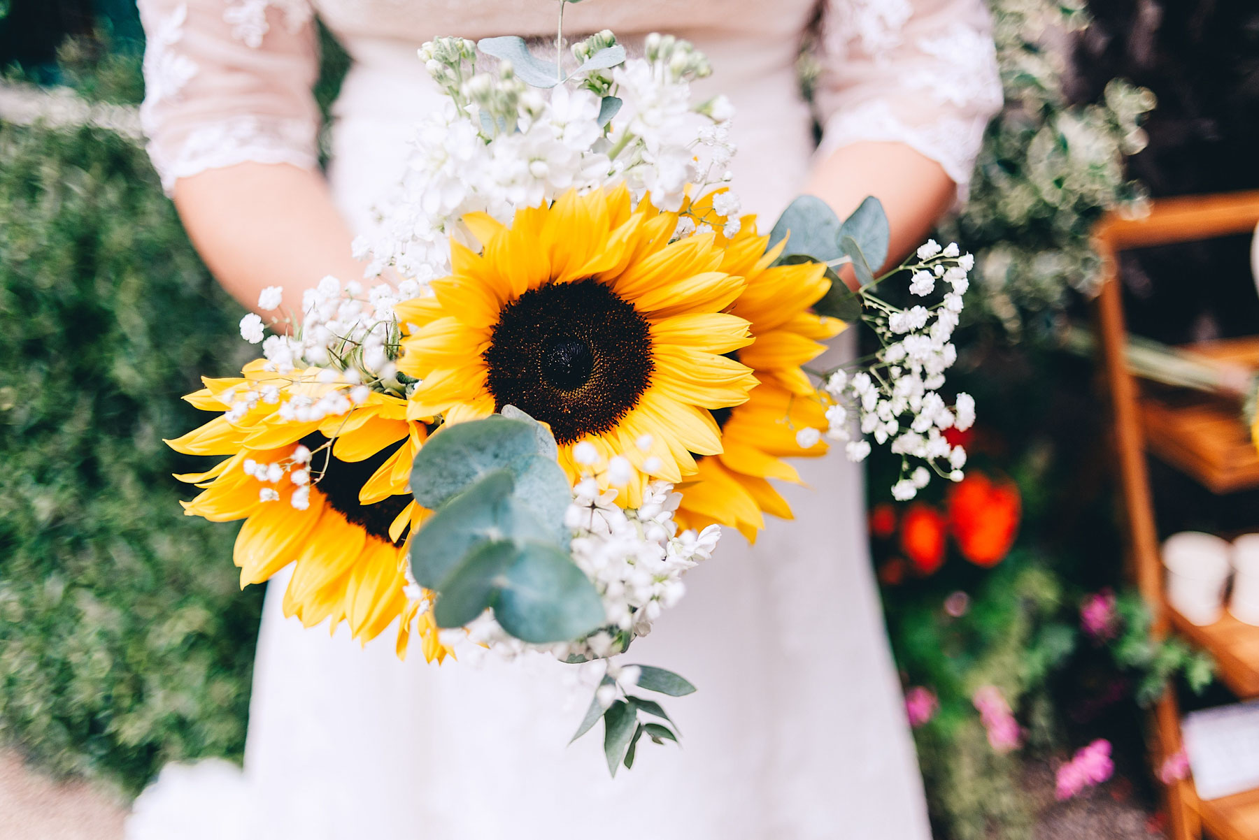 Bride holds a bouquet of sunflowers