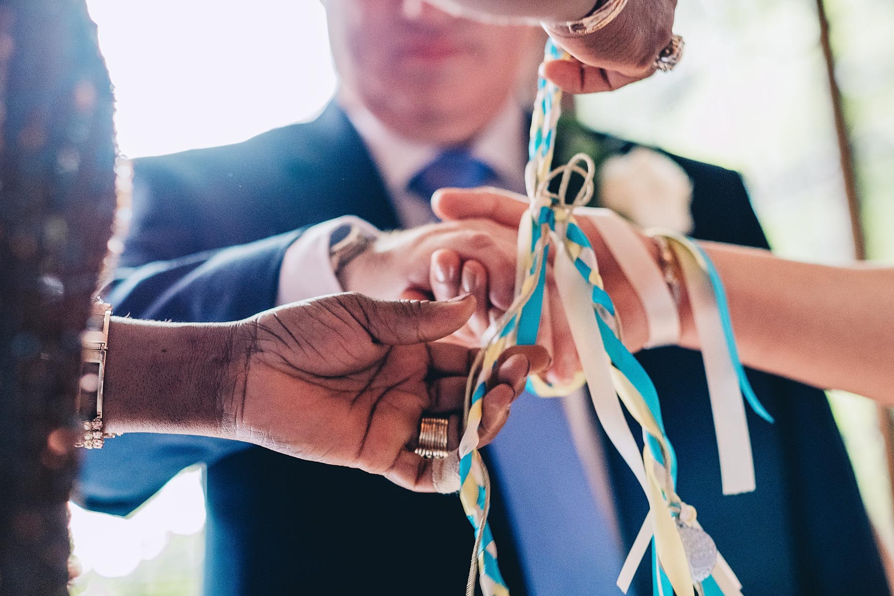 Bride and groom's hands are tied during handfasting