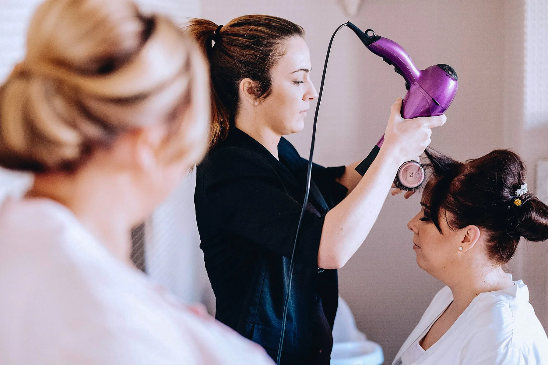 Bride getting her hair styled by a hairdresser