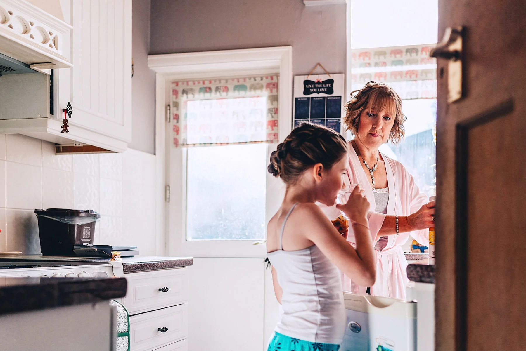 Young girl and woman in the kitchen