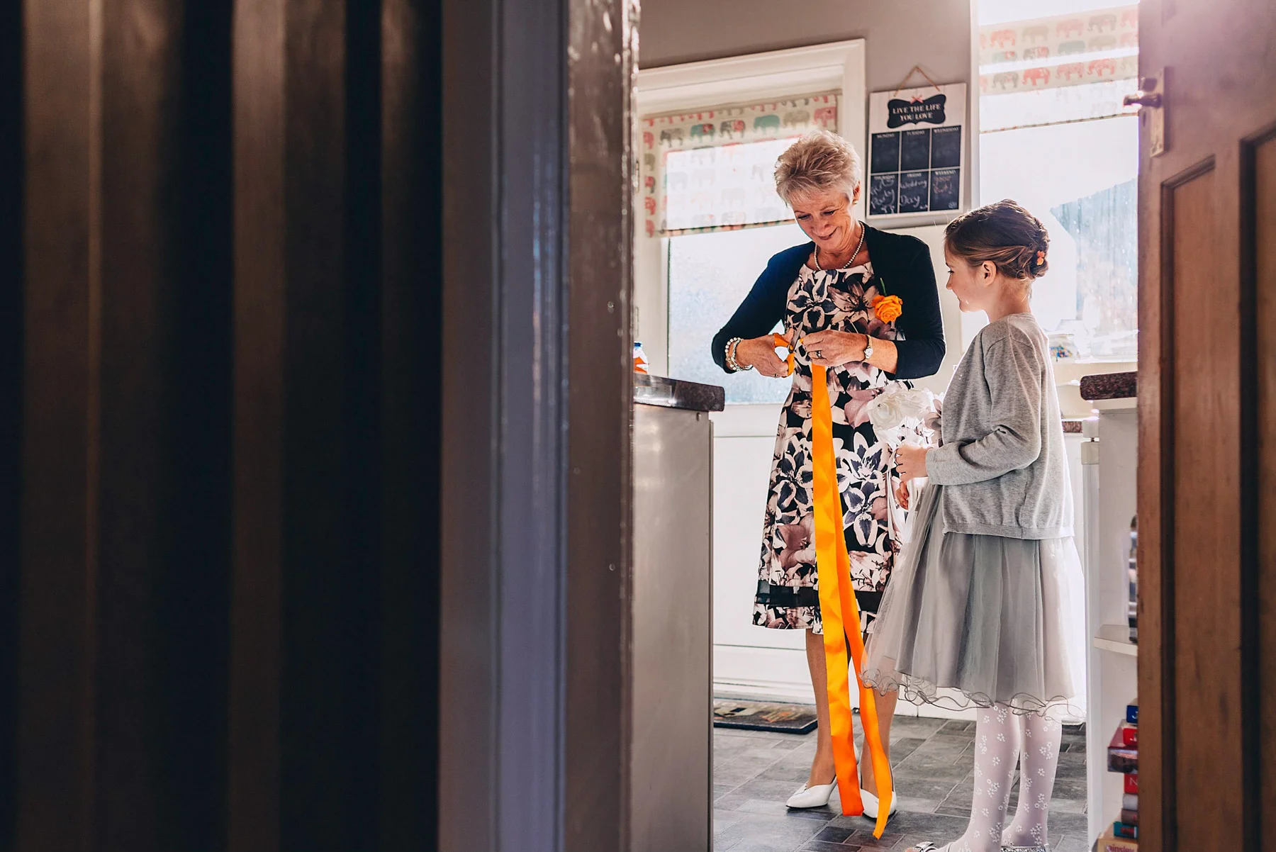 Cutting orange ribbons ready for wedding