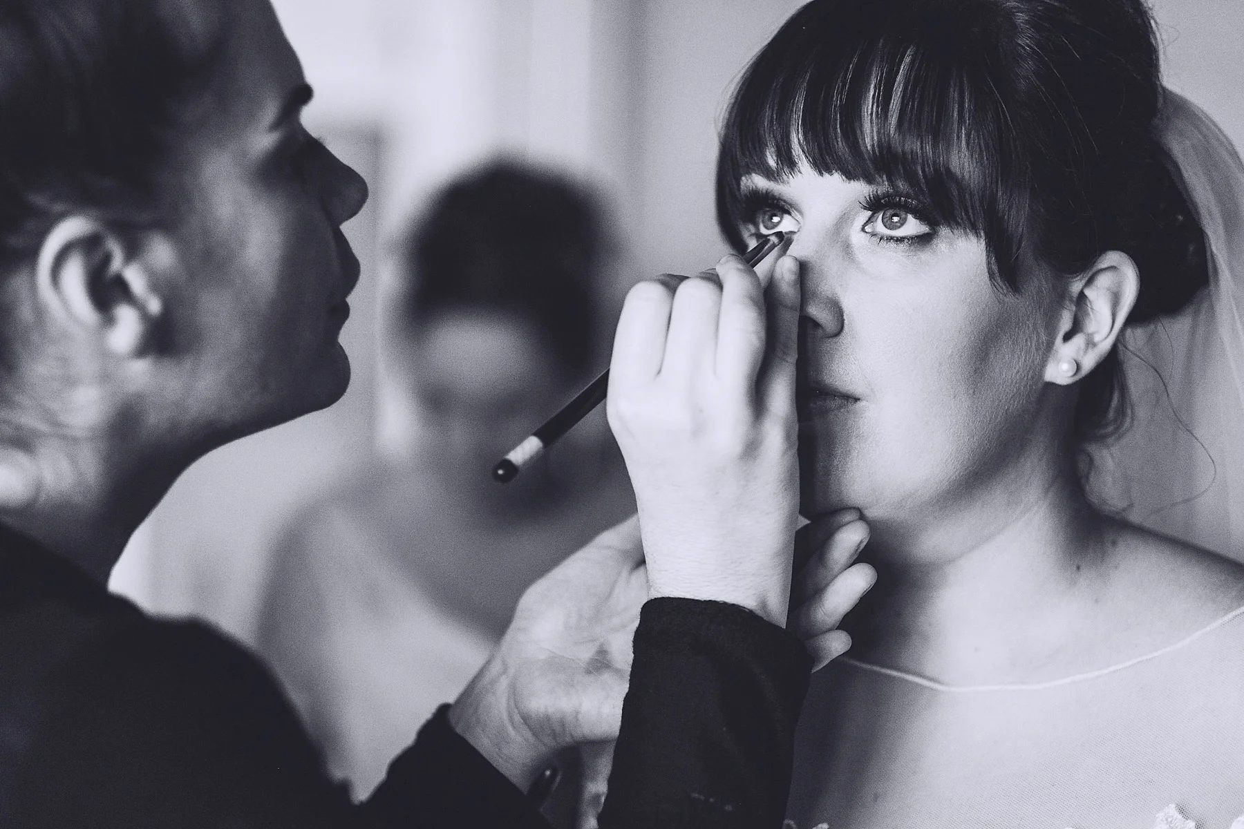 Make up is applied to brides eyes
