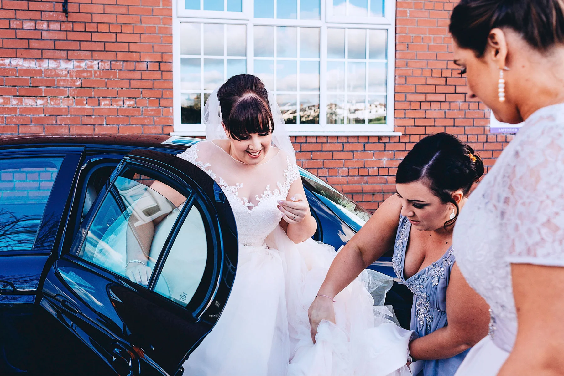 Bride gets out of wedding car