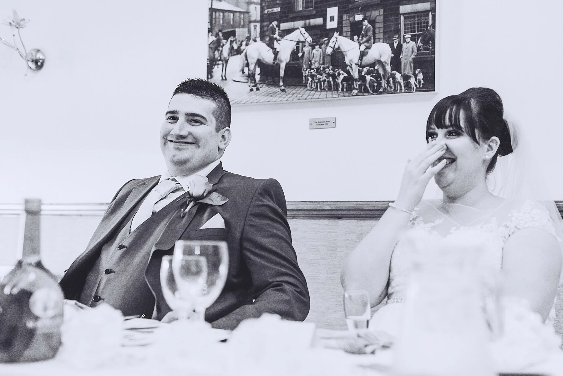 Bride and groom laugh at speech