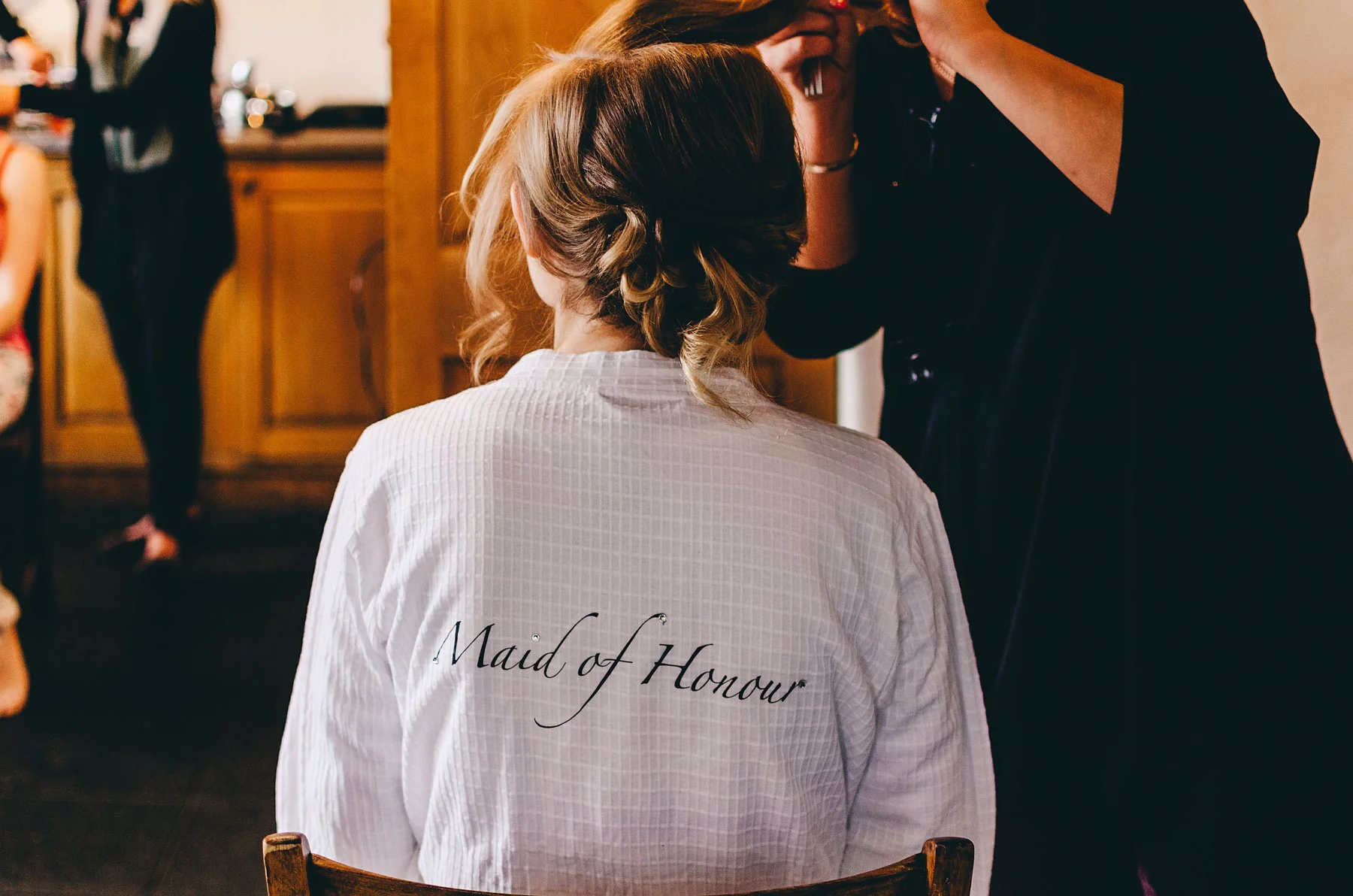 Bridesmaid getting her hair ready for wedding