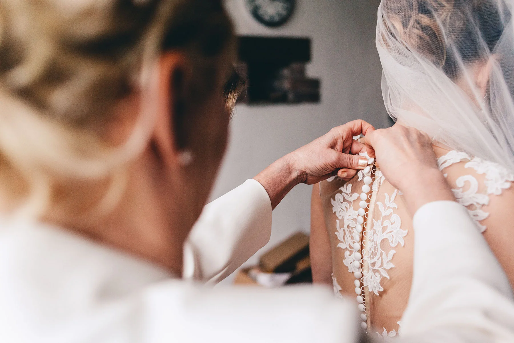 Bridesmaids and Mother of the bride help get beautiful bride get ready, In Rosedew Farm Llantwit Major South Wales