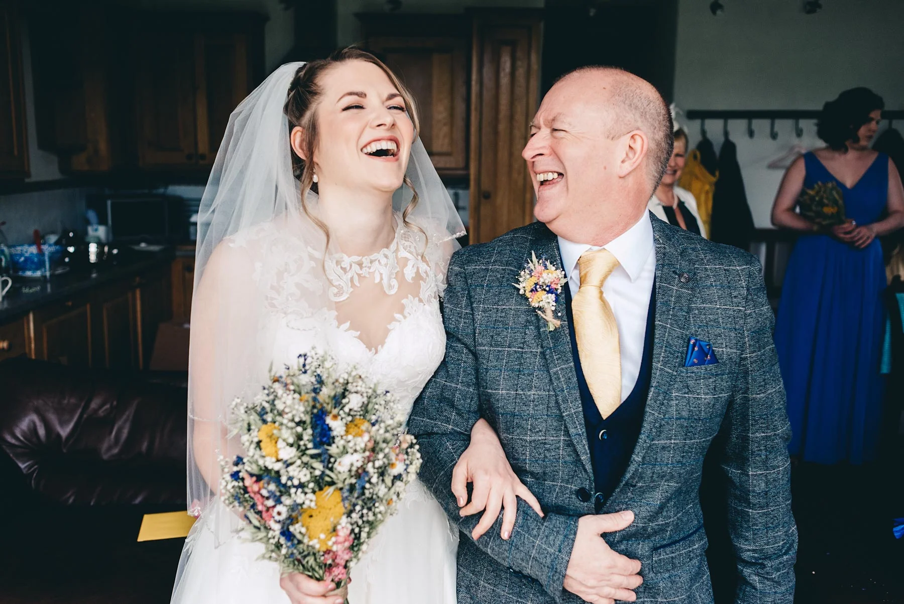Bride laughs with father