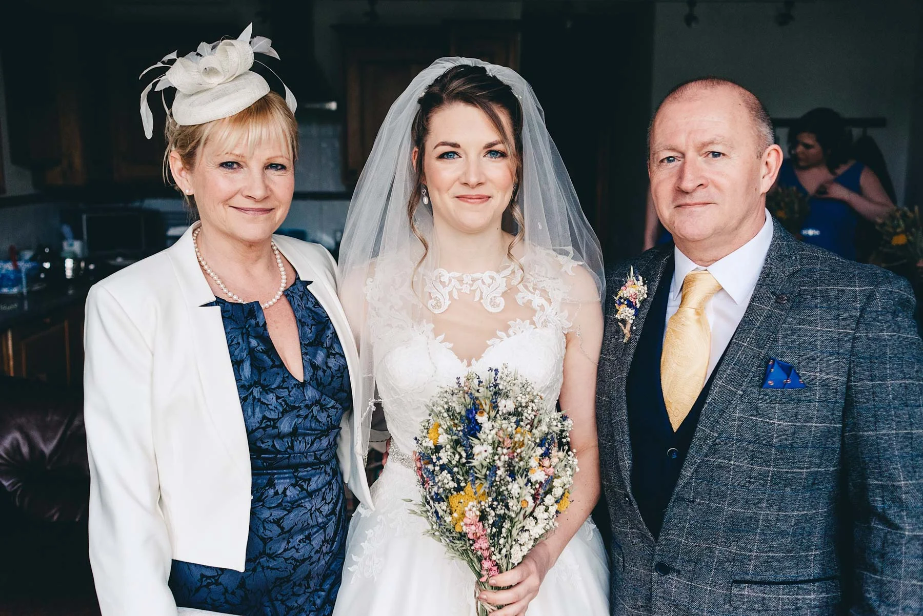Bride poses with mother and father on the morning of the wedding in Rosedew Farm Llantwit Major south Wales