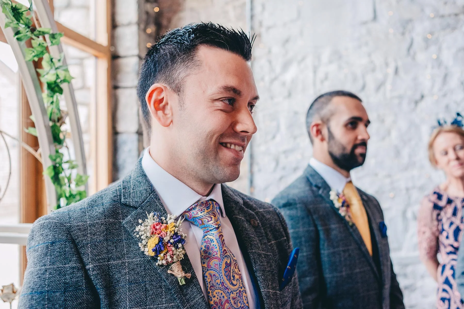 Groom smiles as service starts