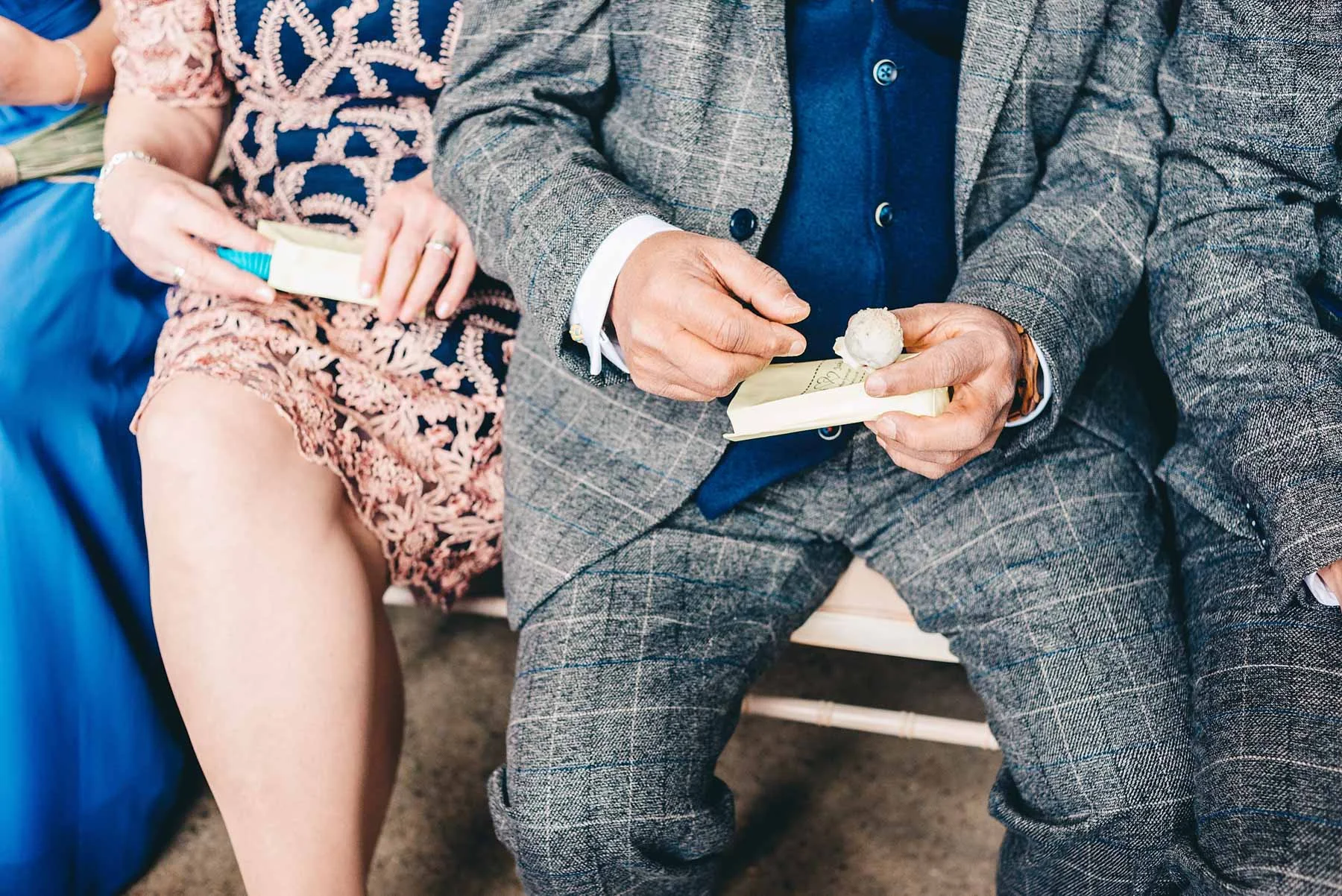 Guests open treats during wedding service