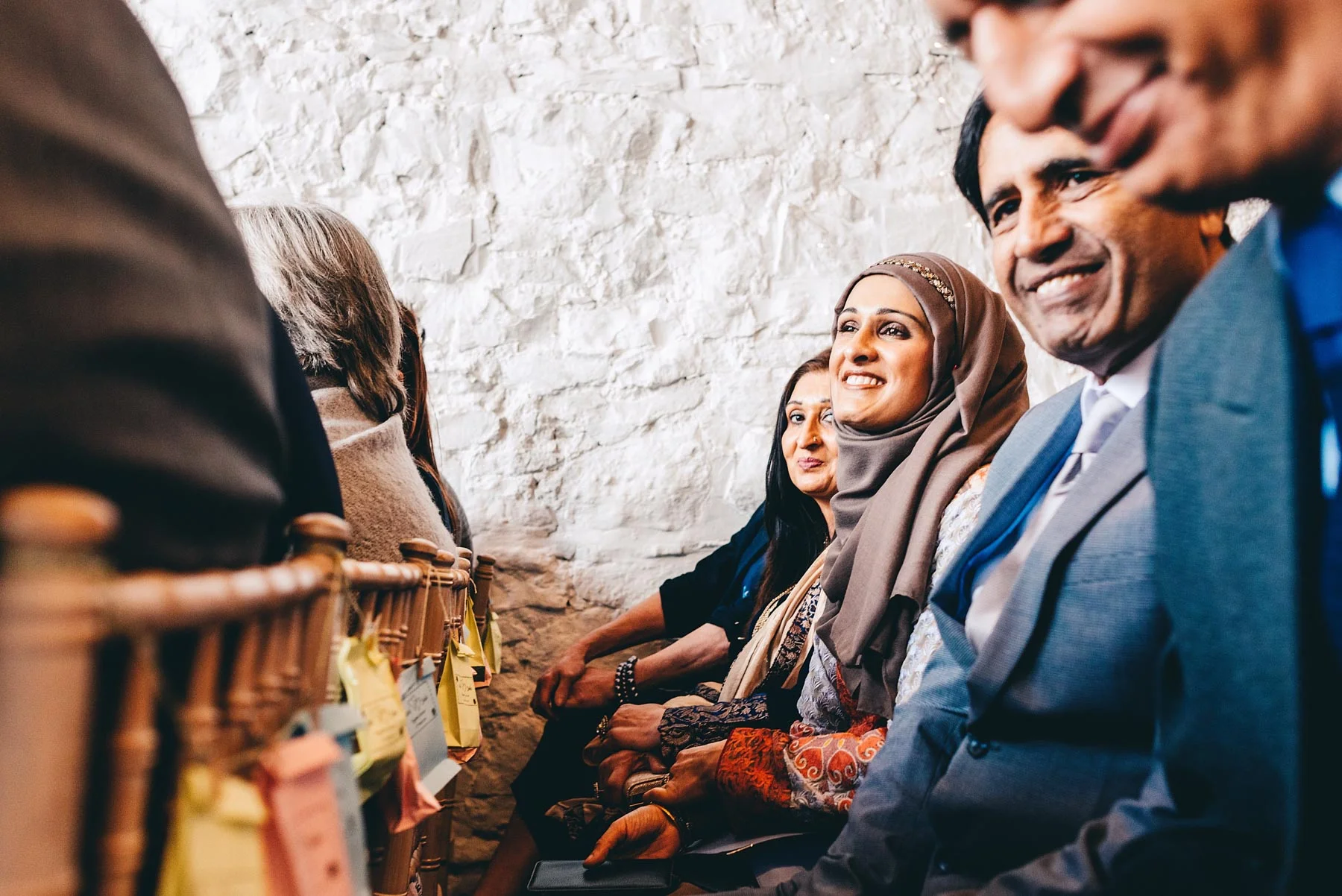 Guests smile at wedding taking place
