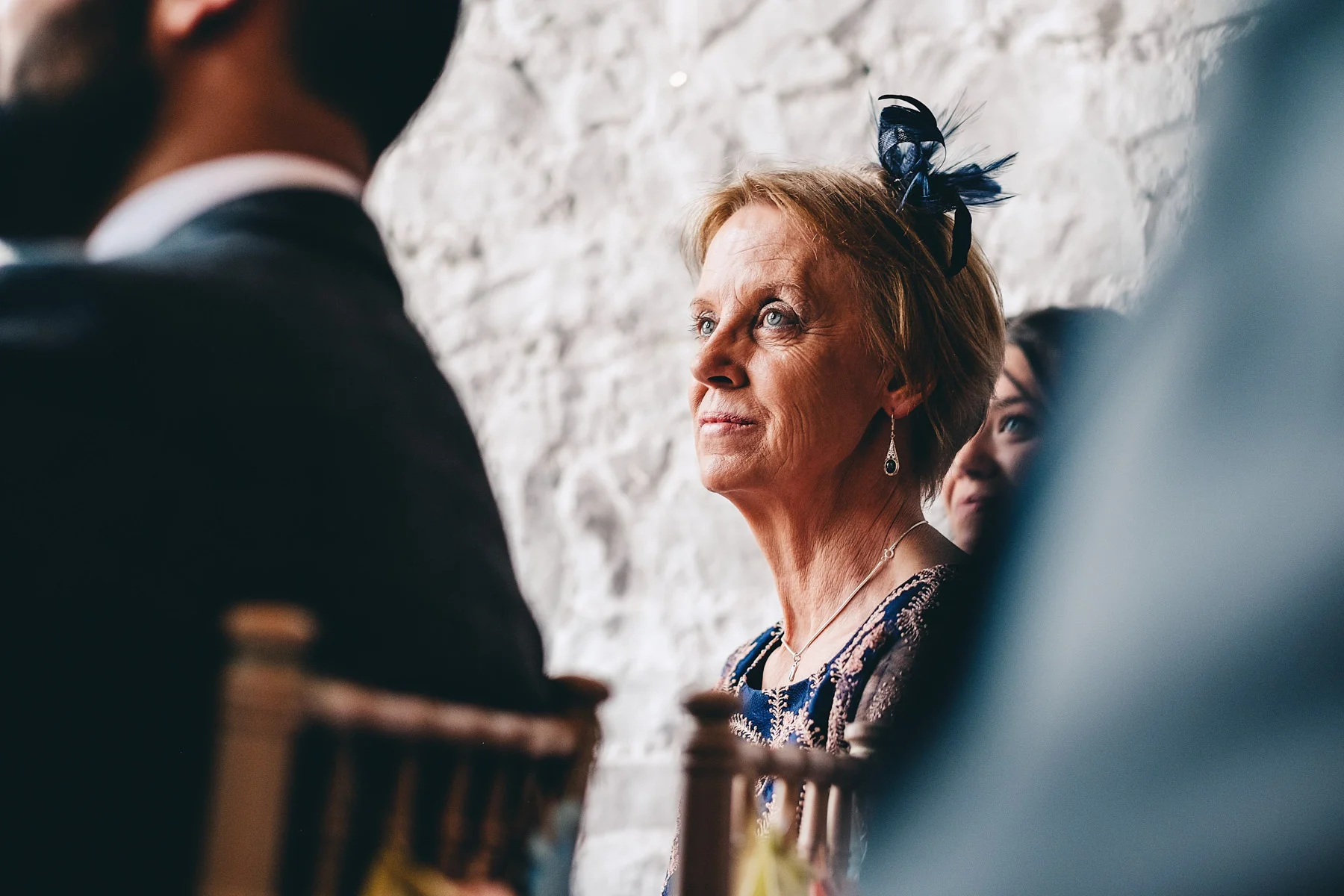 Mother of the groom looks on at wedding