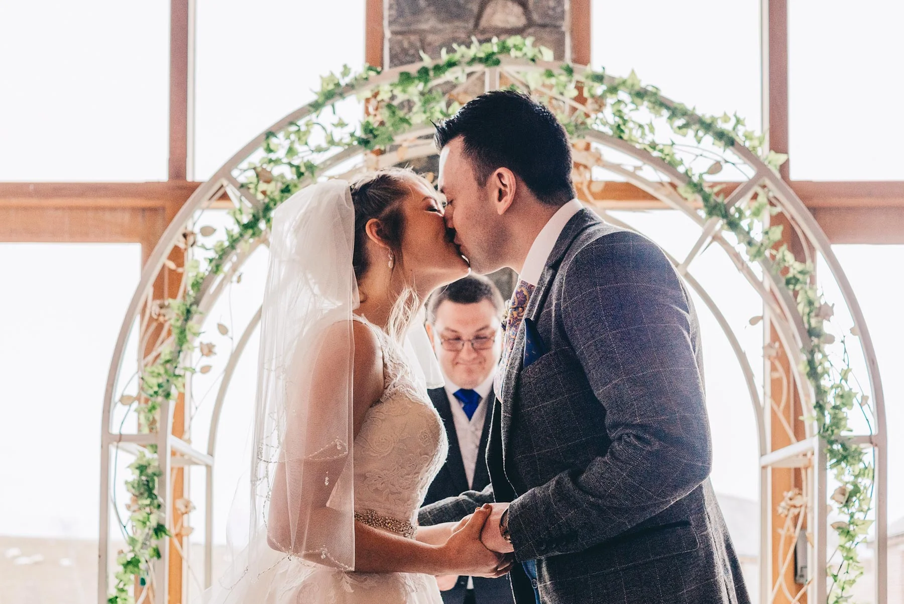 Bride and Groom kiss during wedding service at Rosedew Farm, Llantwit Major, South Wales
