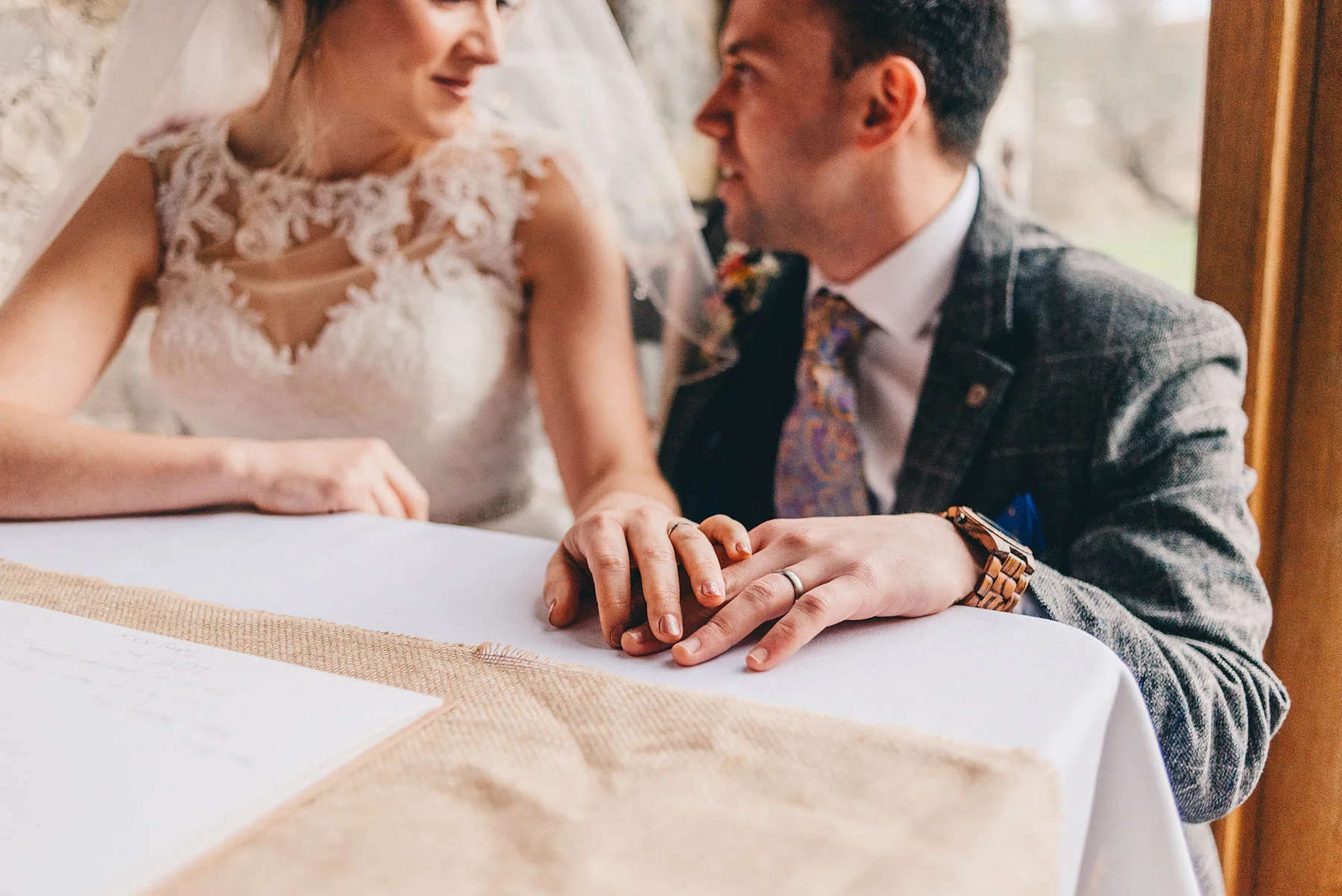 Bride and grooms hands showing rings after service