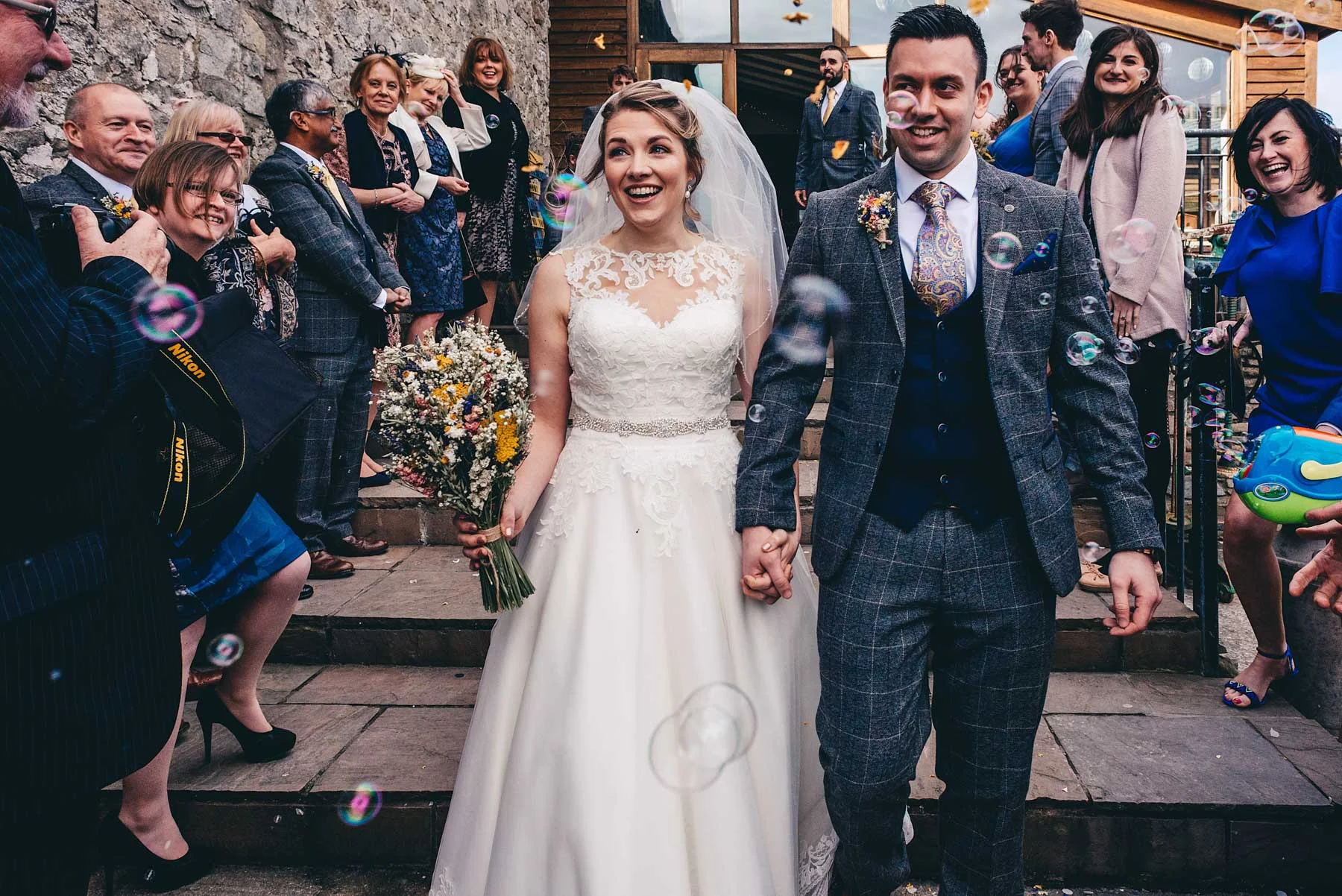 Bride and Groom have confetti thrown at them