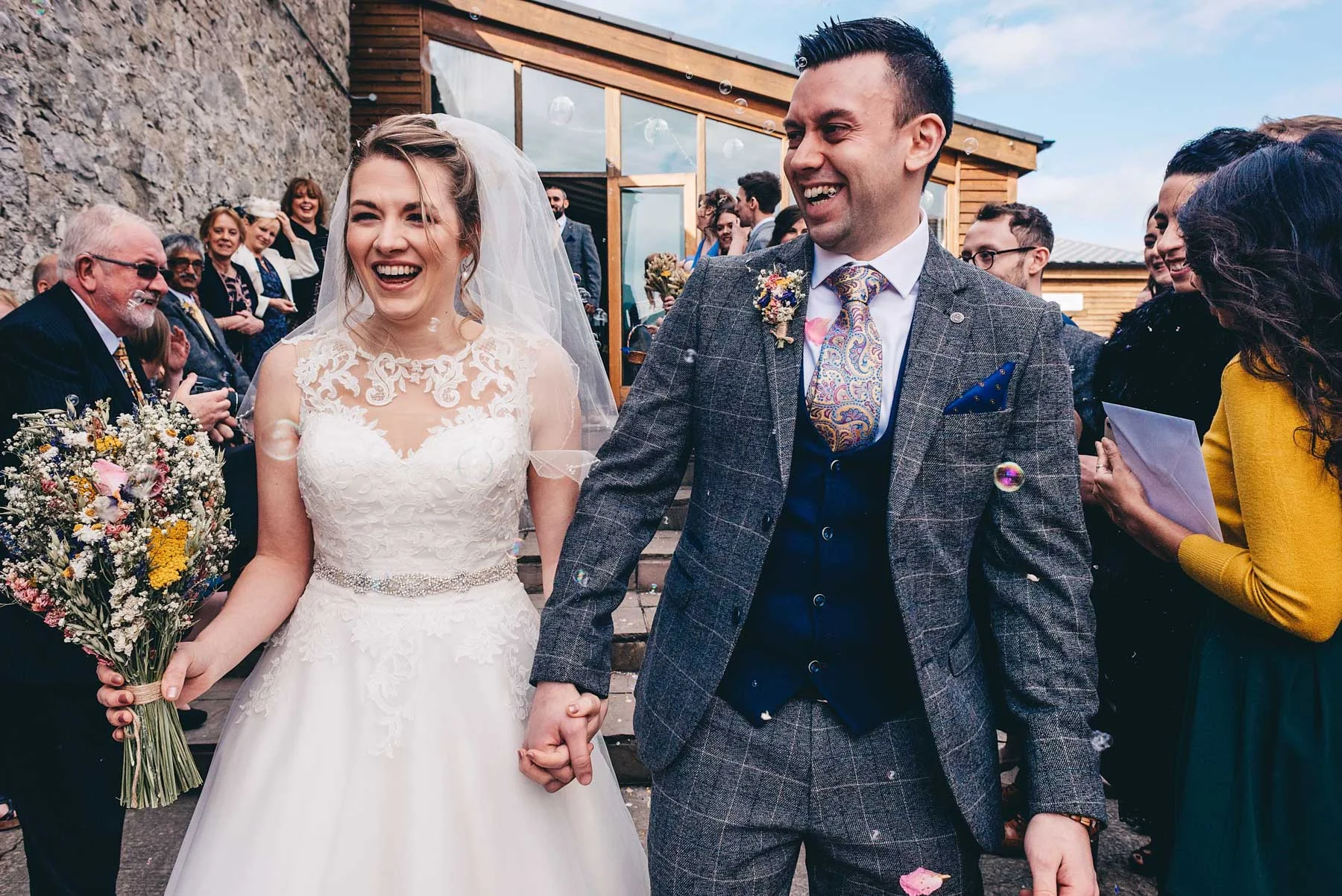 Bride and Groom have confetti thrown at them
